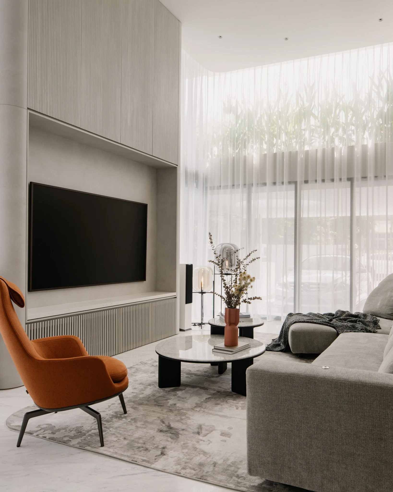Double volume living room with pop of colour with chair