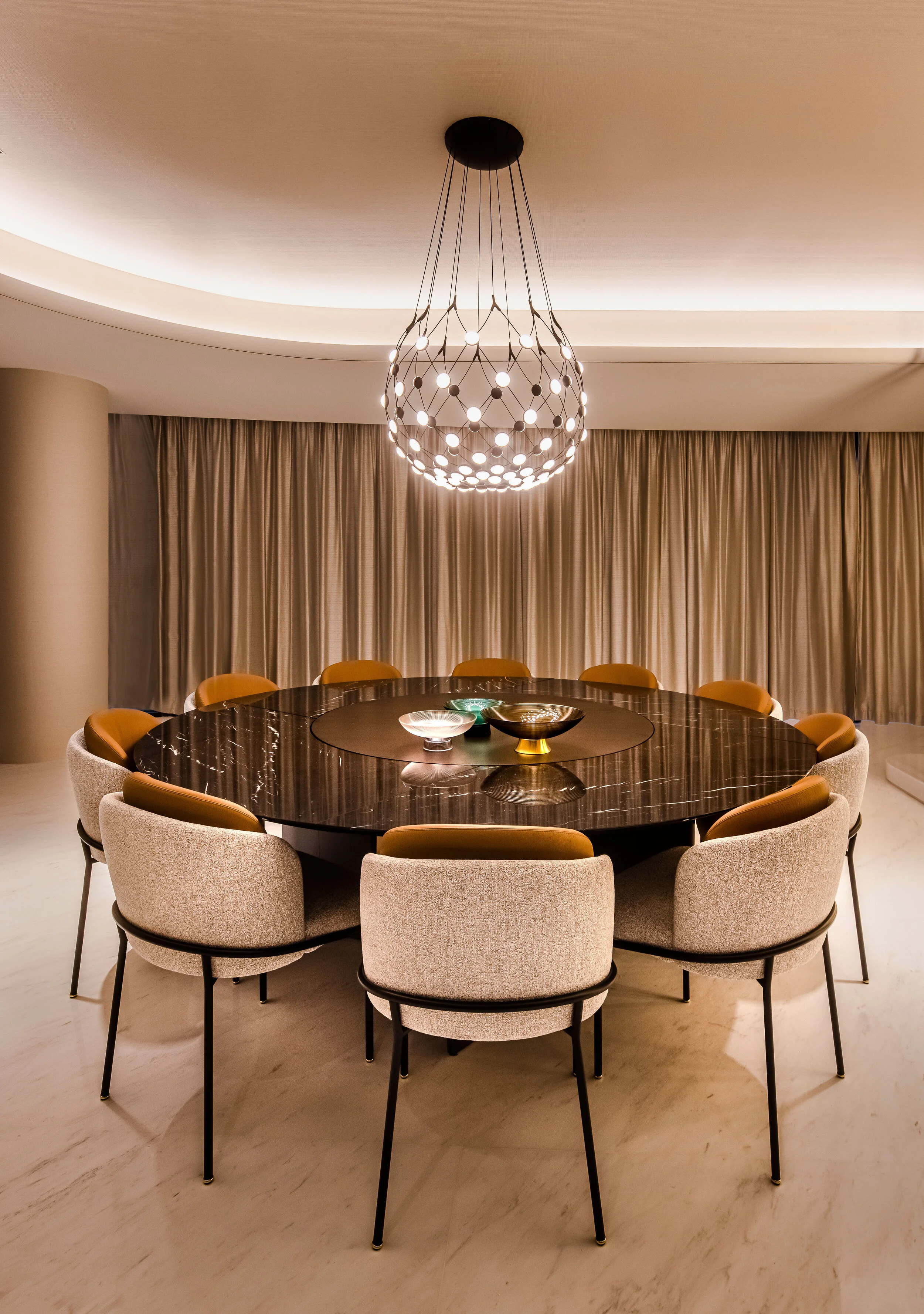 round dining table with seats and pendant light above