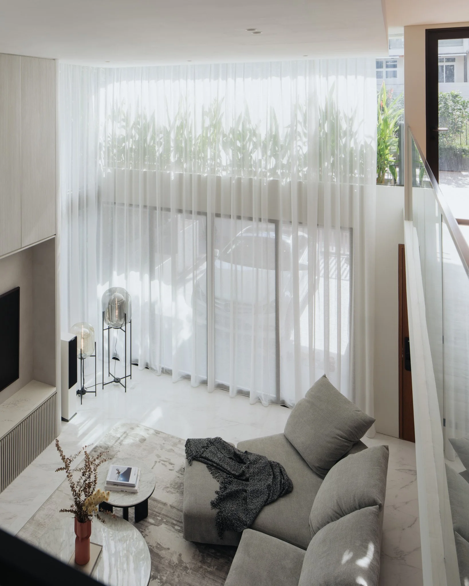 View from mezzanine into double volume living room