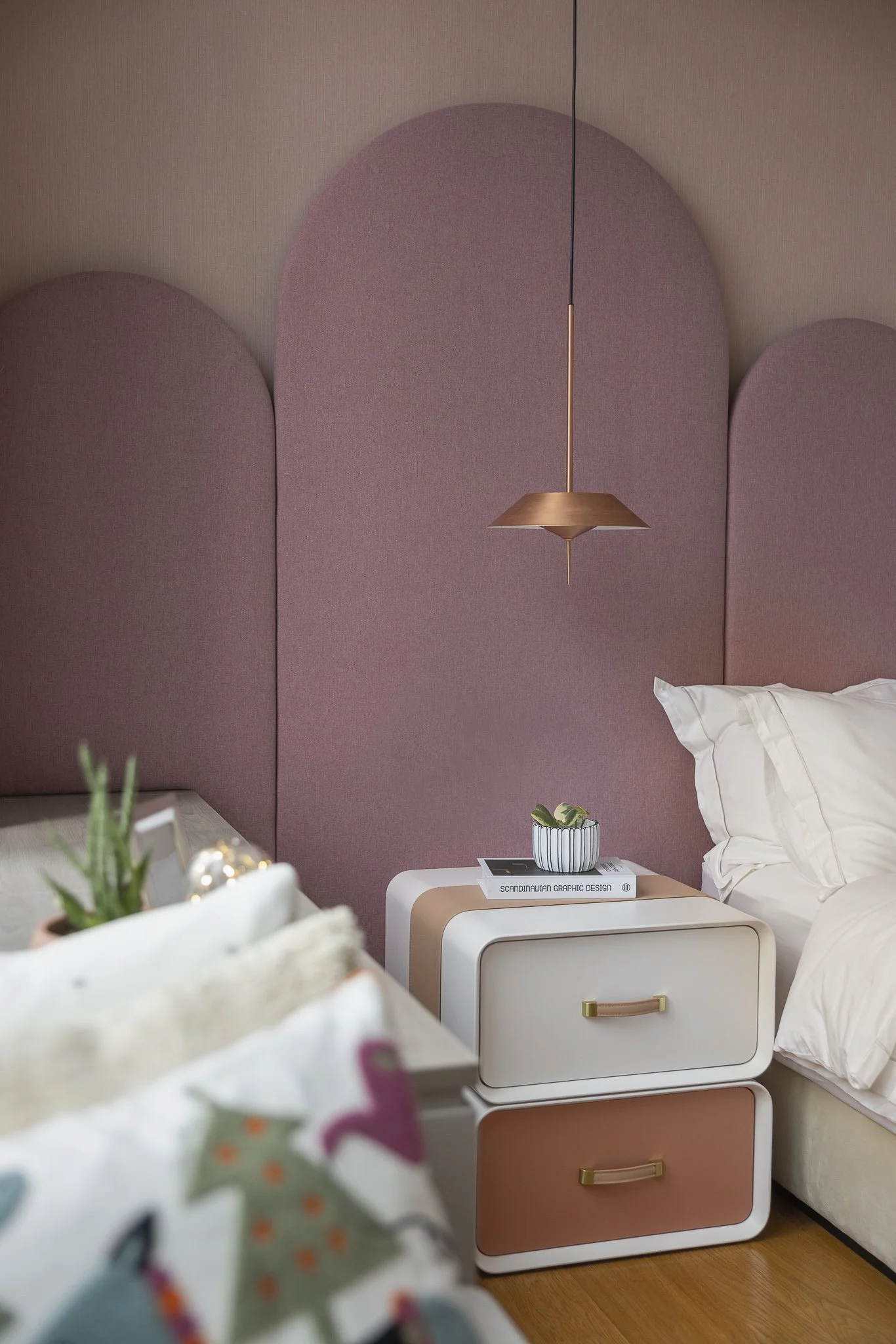 Interior design. Clean, contemporary youthful bedroom with pops of pink and orange tones.