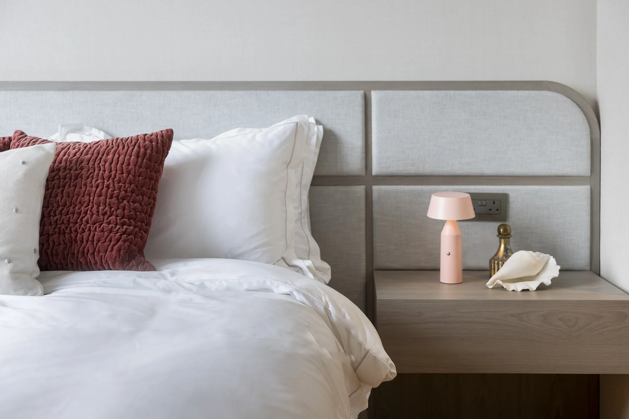 Interior design. Clean, contemporary youthful bedroom with pops of rust and pink tones.