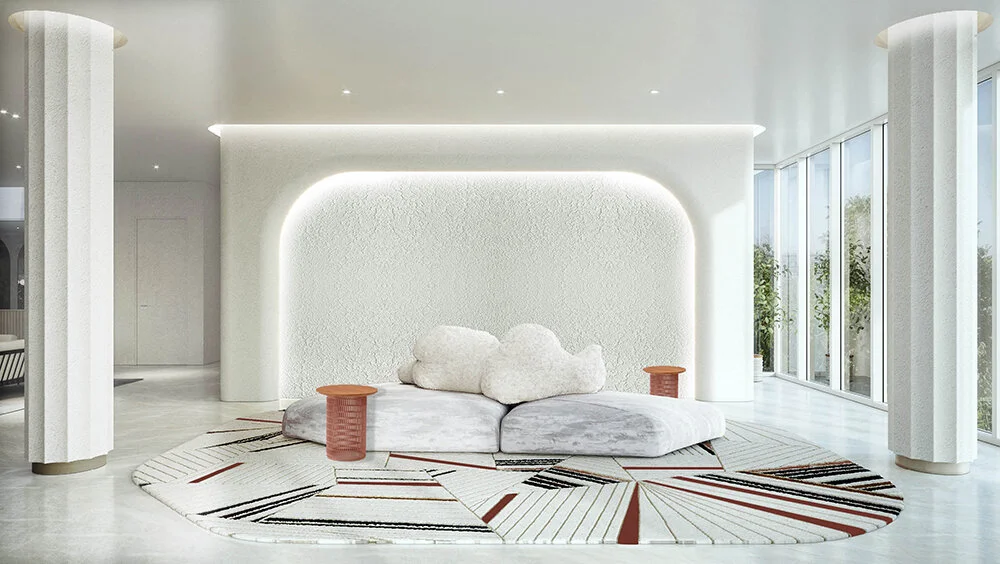 sculptural seating on a patterned rug, with an arched recess in wall behind and a column each on either side of furniture