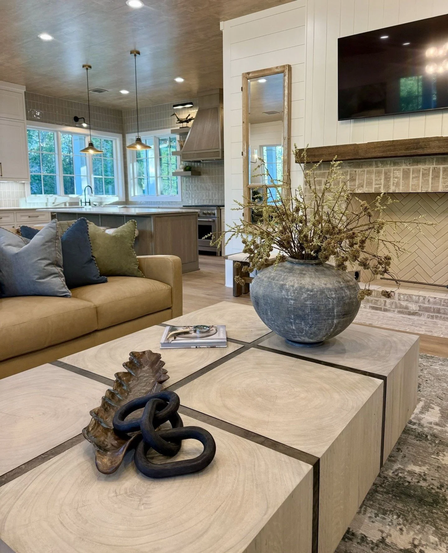 Where modern comfort meets rustic charm.⁠
⁠
This living space is all about balance&mdash;warm wood tones, layered textures, soft neutrals, and thoughtfully curated details that make the room feel both elevated and inviting. From the statement coffee 