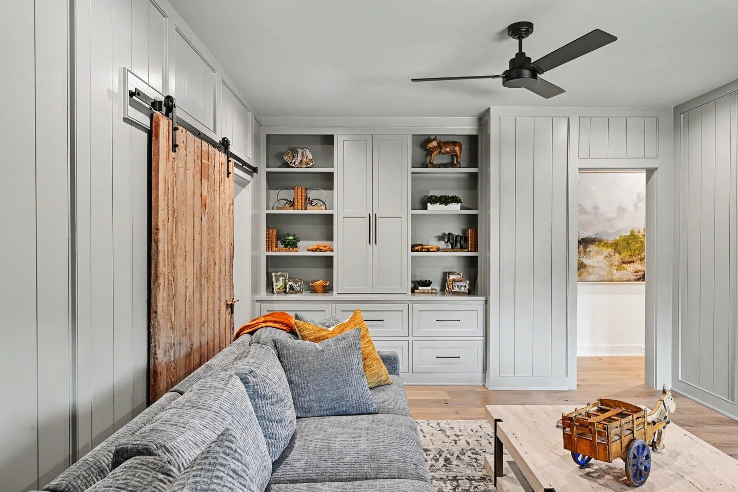 A game room designed for the whole family. 🤍⁠
⁠
A beautiful oversized gray sectional gives everyone a place to settle in, while hidden storage keeps the space clean and clutter-free. Layered accessories bring it all together&mdash;and can we talk ab