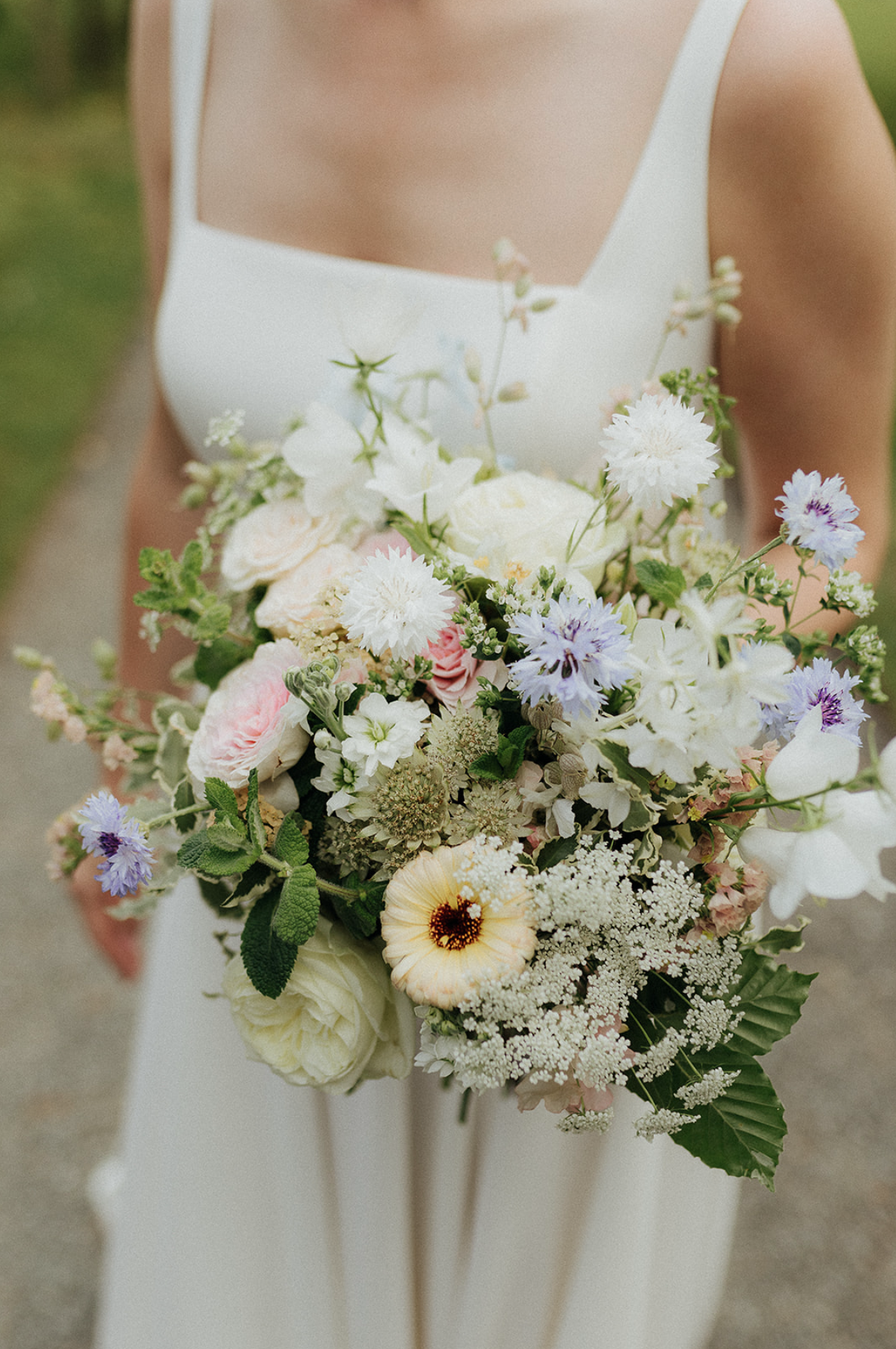 Bride holding bouquet at Llangoed Hall wedding in Brecon