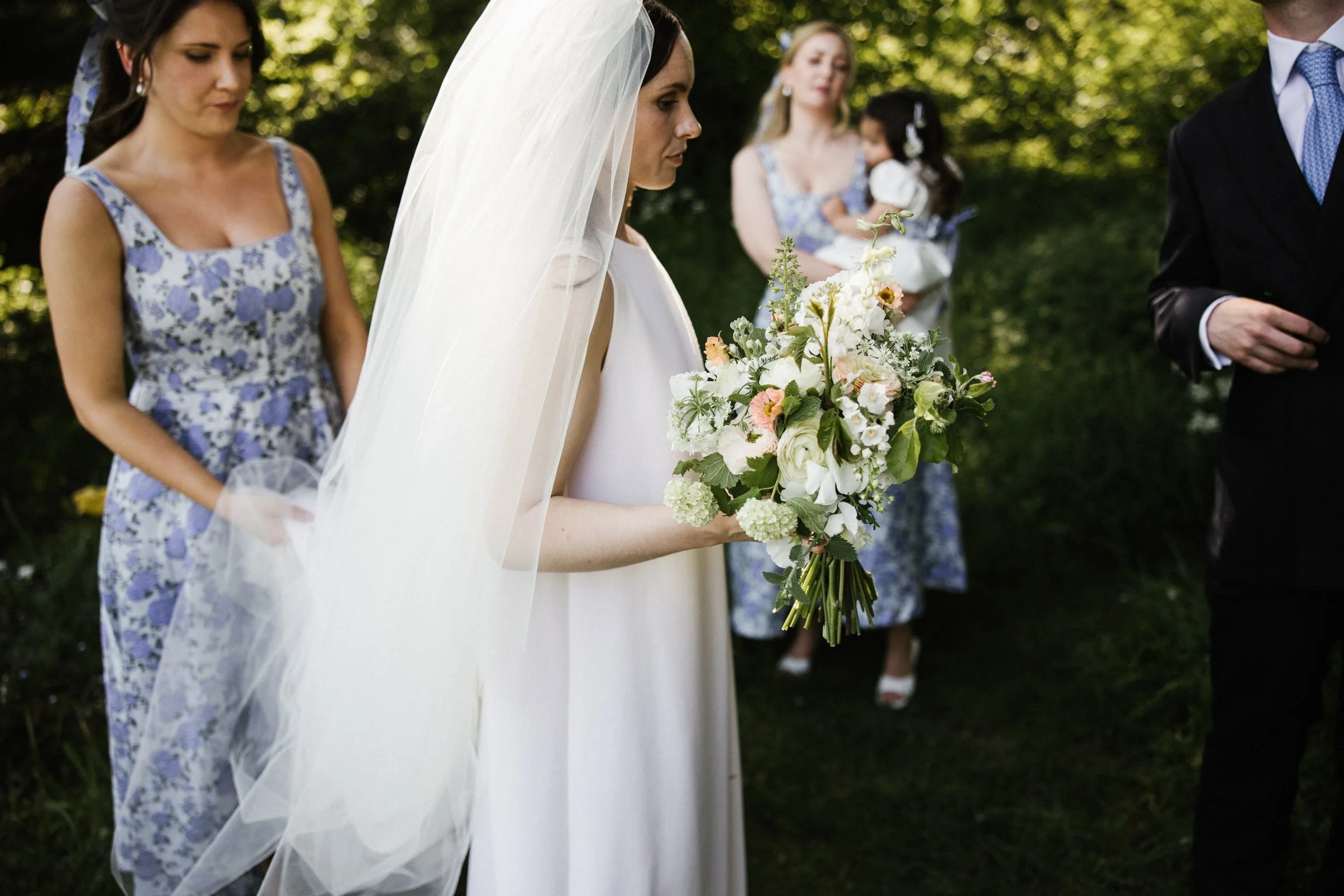 Bride holding wedding flowers at Penrice Estate Wedding, Gower