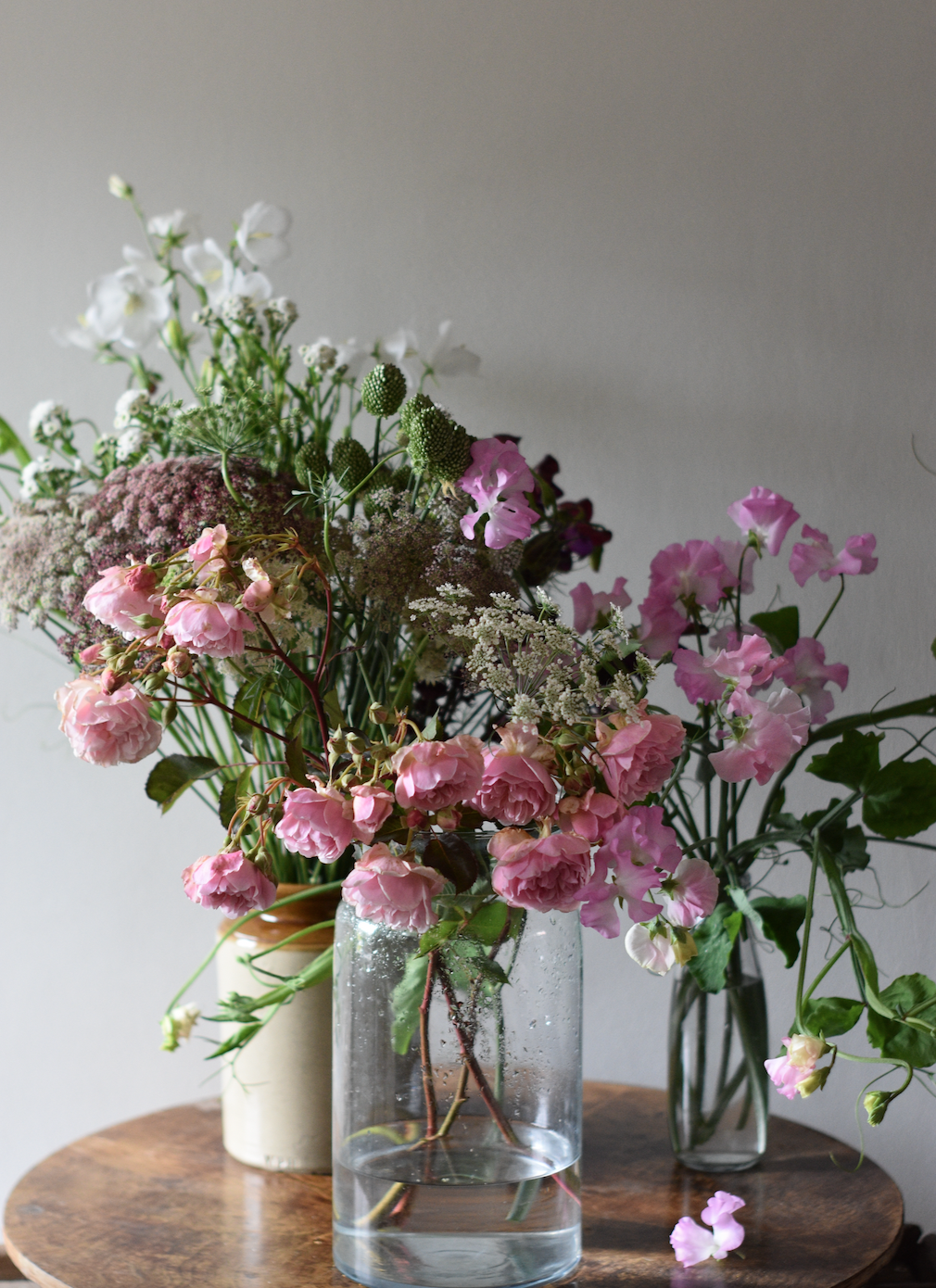 Roses and sweet pea flowers in vases
