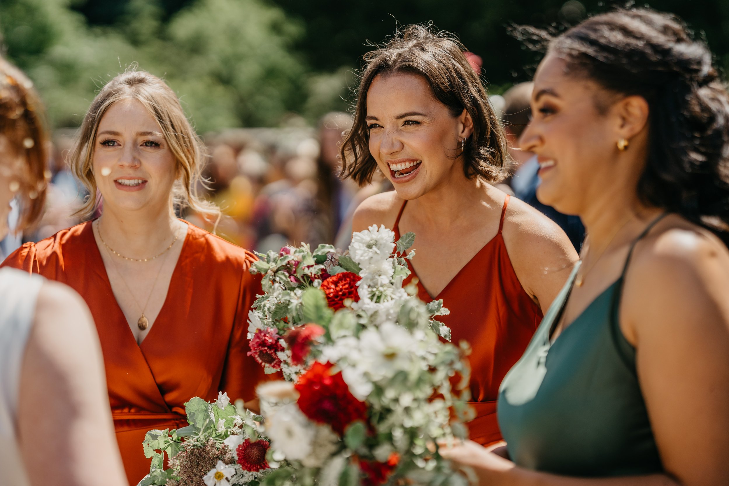 Bridesmaids with flowers at Cripps Barn wedding, Bibury