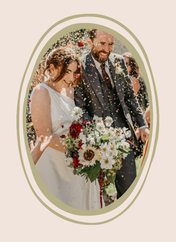 Bride and groom with wedding flower bouquet at Cripps Barn, Bibury