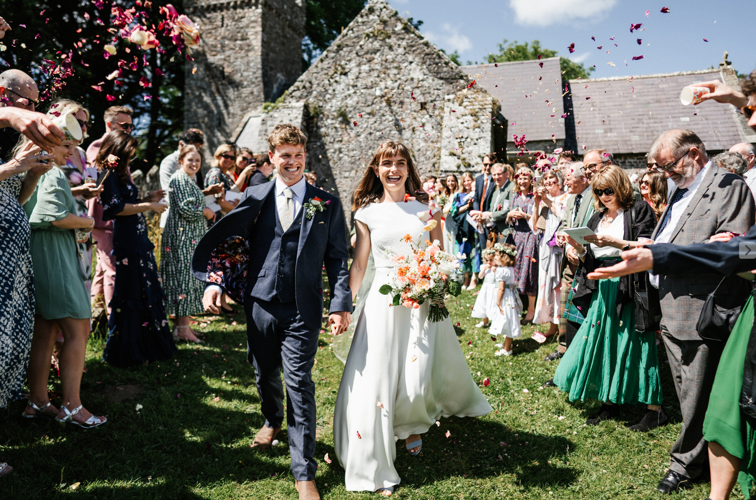 Bride and groom outside St Andrew's church, Penrice, Gower