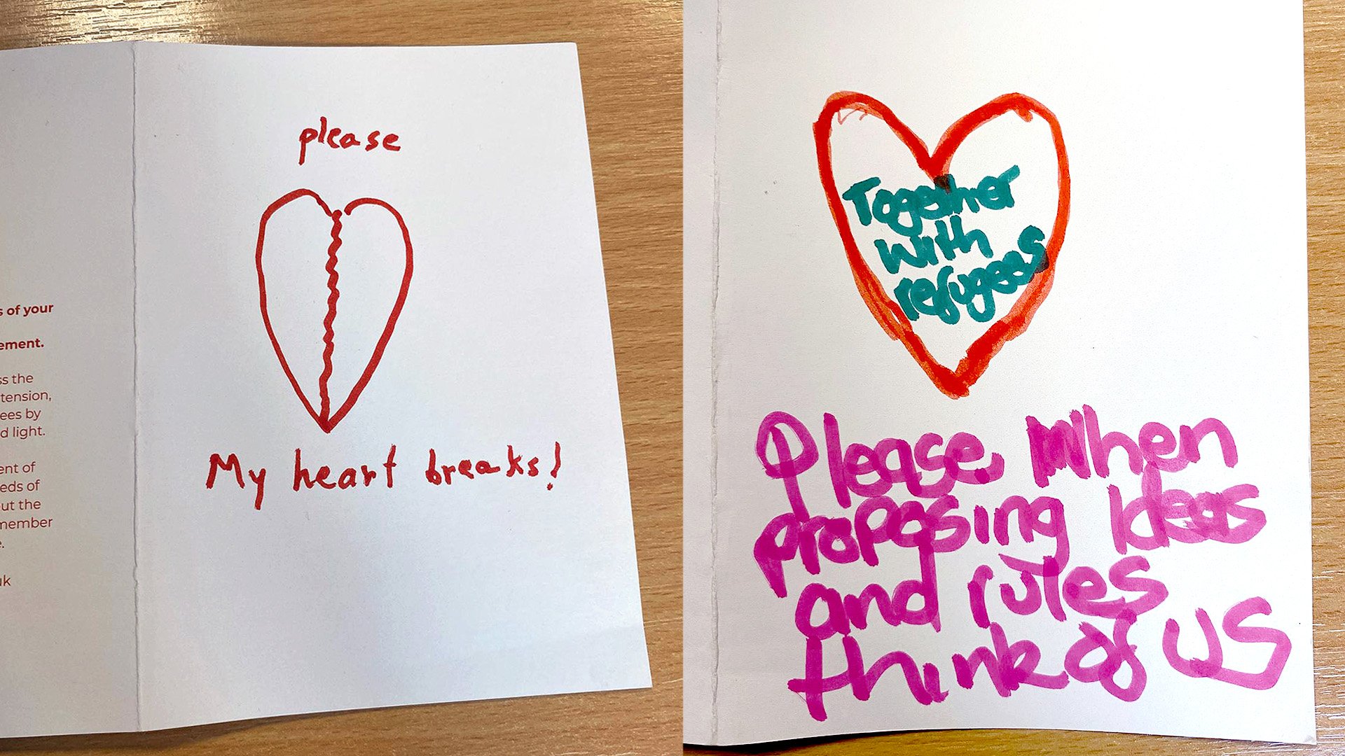 Photograph of women's drawings on the front of Together With Refugee cards. The drawings show broken hearts, asking "Please, my heart breaks!" and "Please, when proposing ideas and rules think of us."