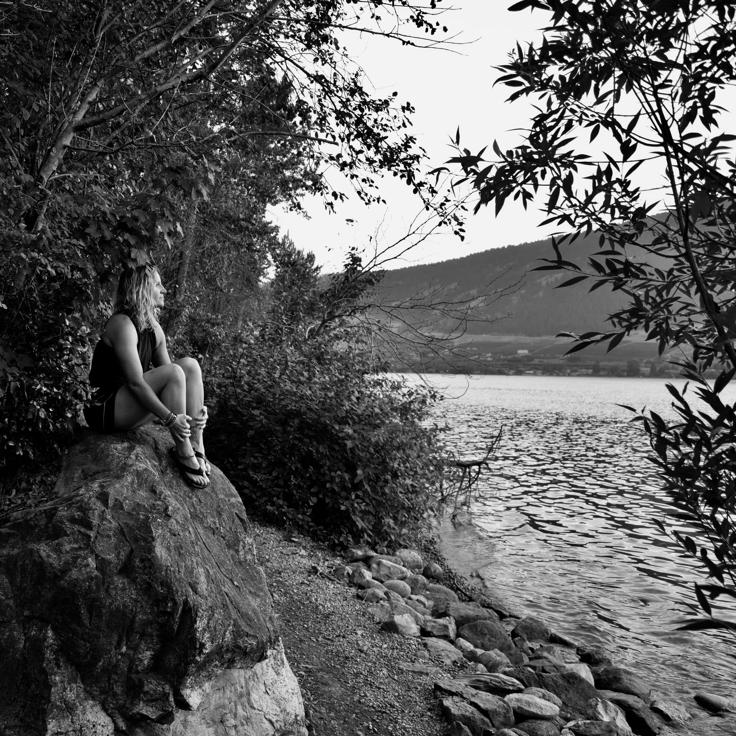 Melissa Lynn Sharp looking out over Okanagan Lake at sunset.