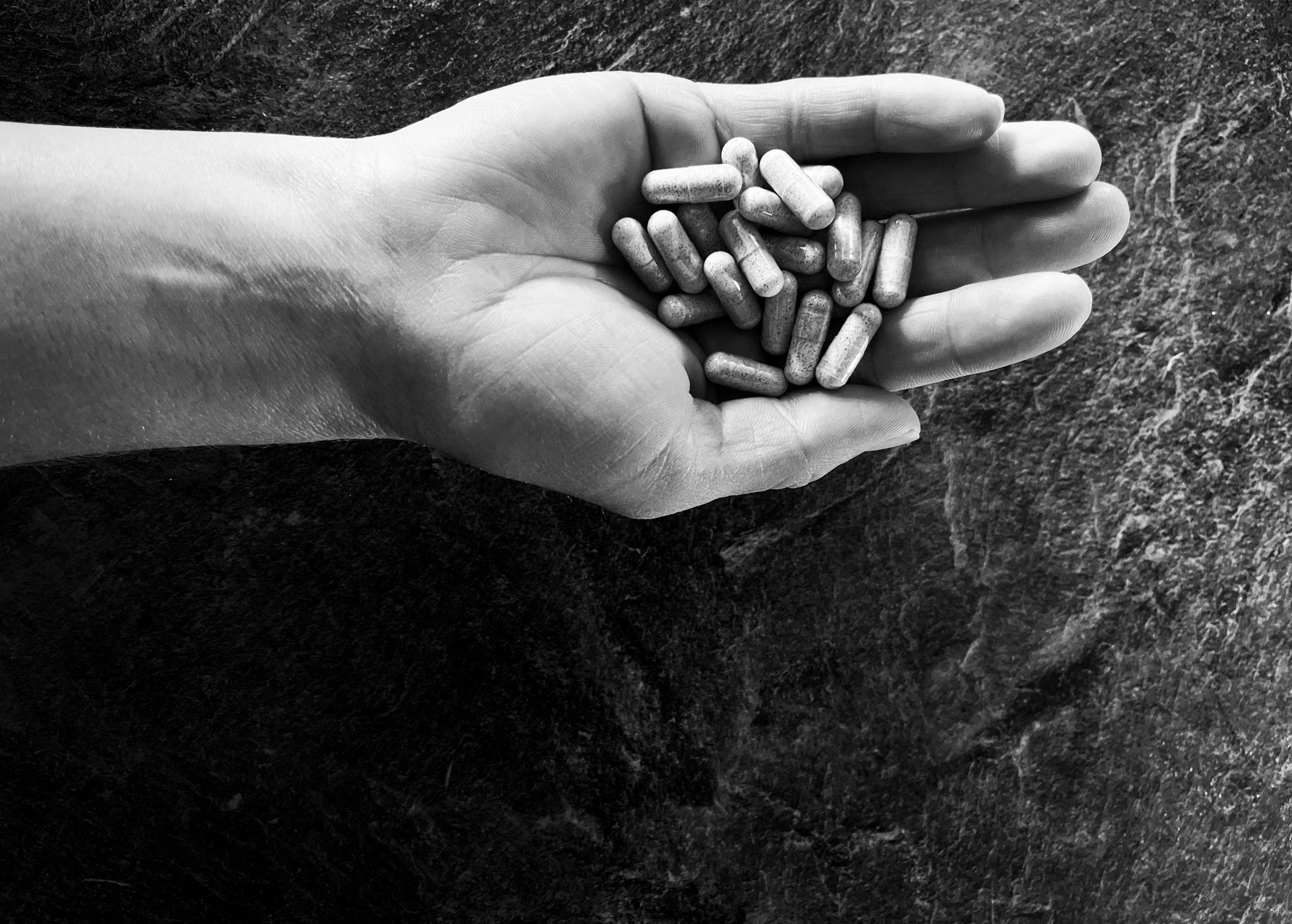 Hand holding medication representing self-advocacy, personal agency, and making informed decisions within the medical system.