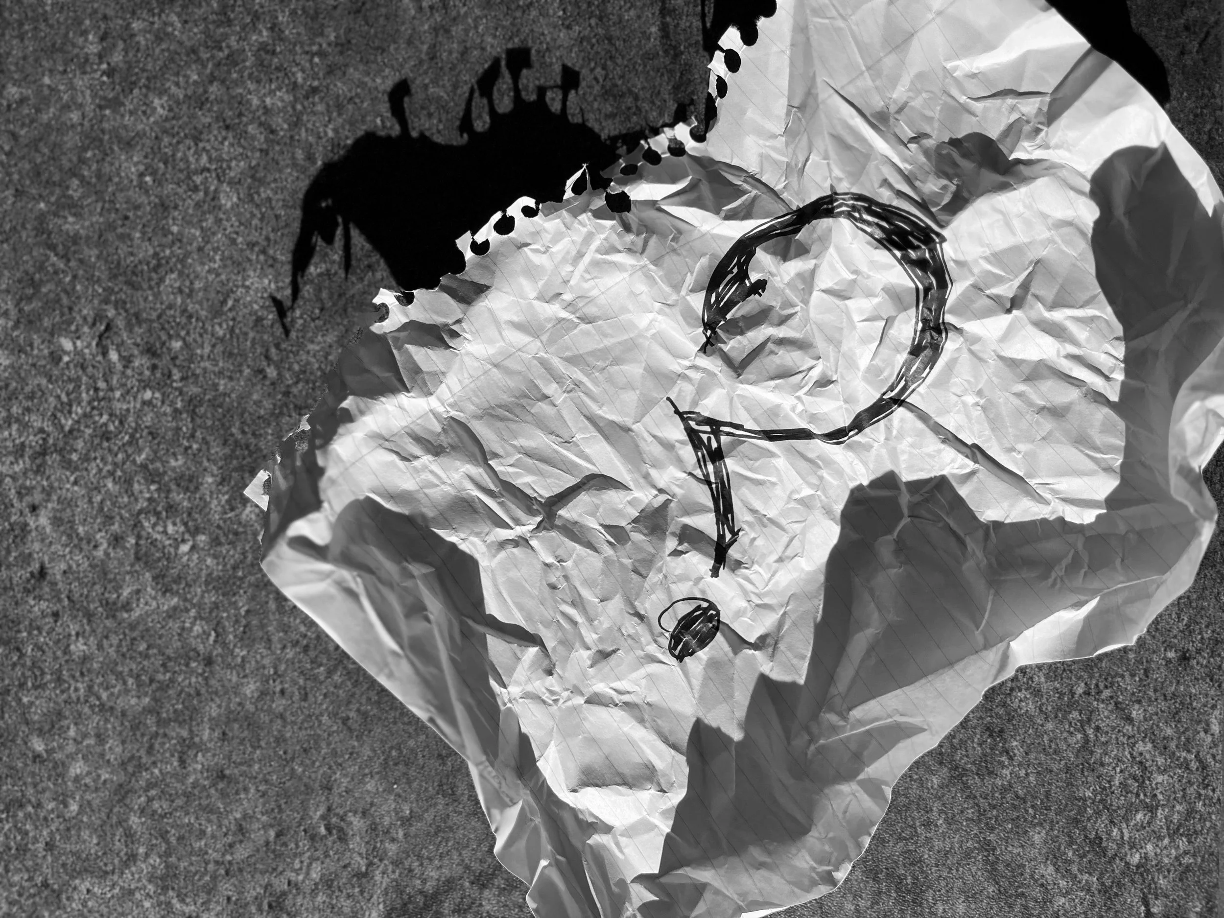 A crumpled piece of lined paper with a hand-drawn question mark representing curiosity, discernment, and critical thinking.