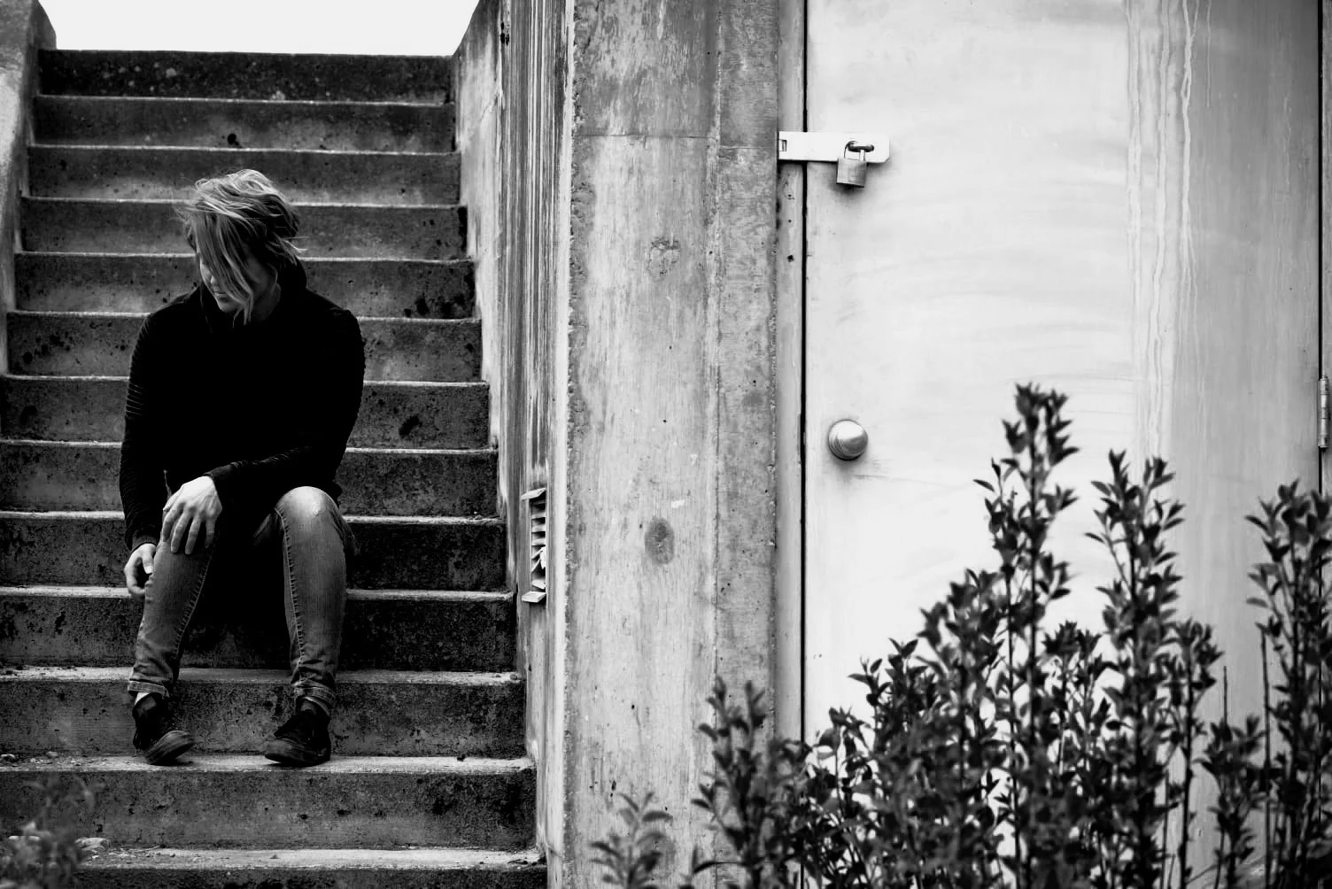 Melissa Lynn Sharp sitting thoughtfully on an outdoor staircase, symbolizing self-reflection and understanding the nervous system.