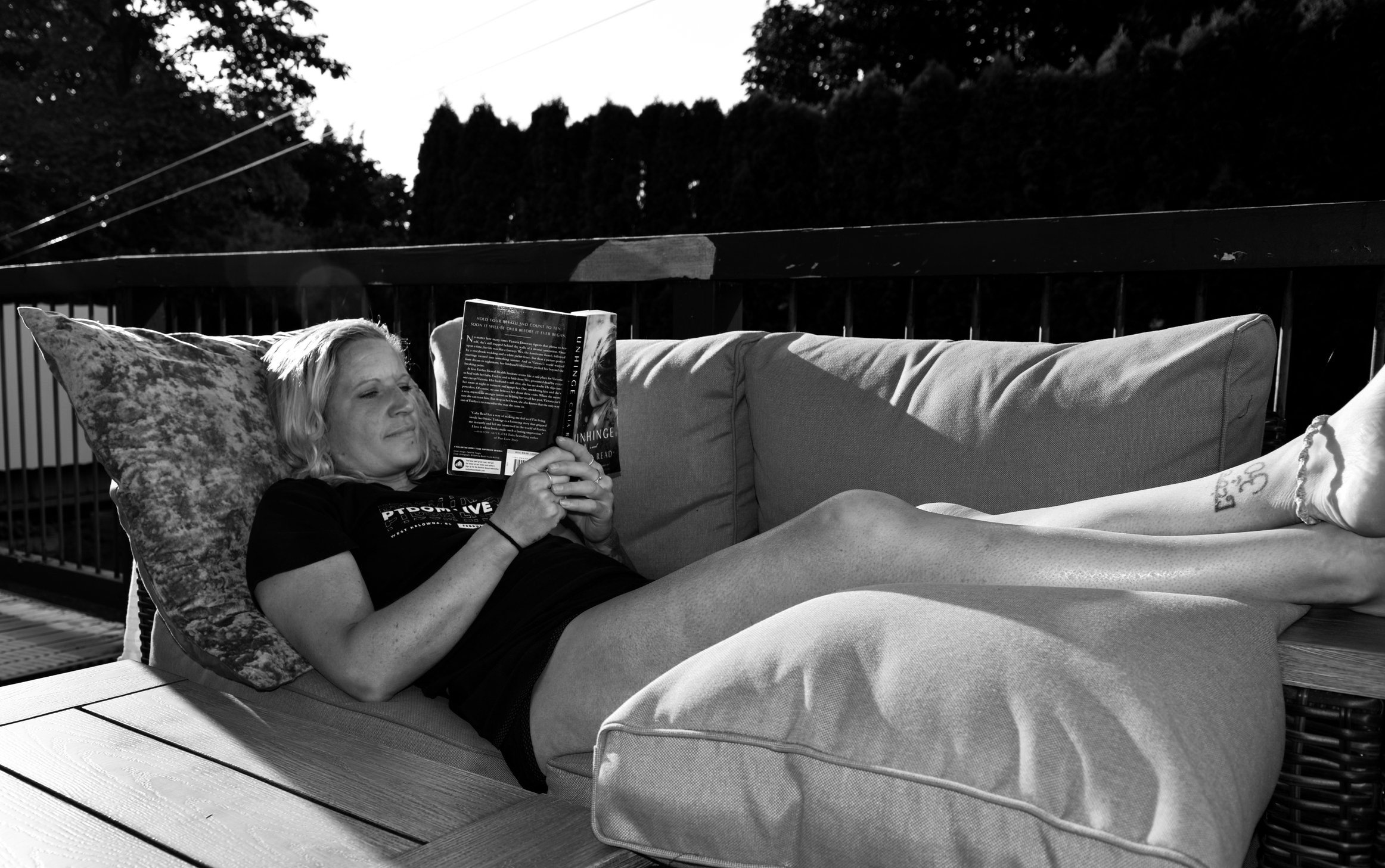 Melissa Lynn Sharp reading on a couch, reflecting on focus, purpose, and the myth of work-life balance.