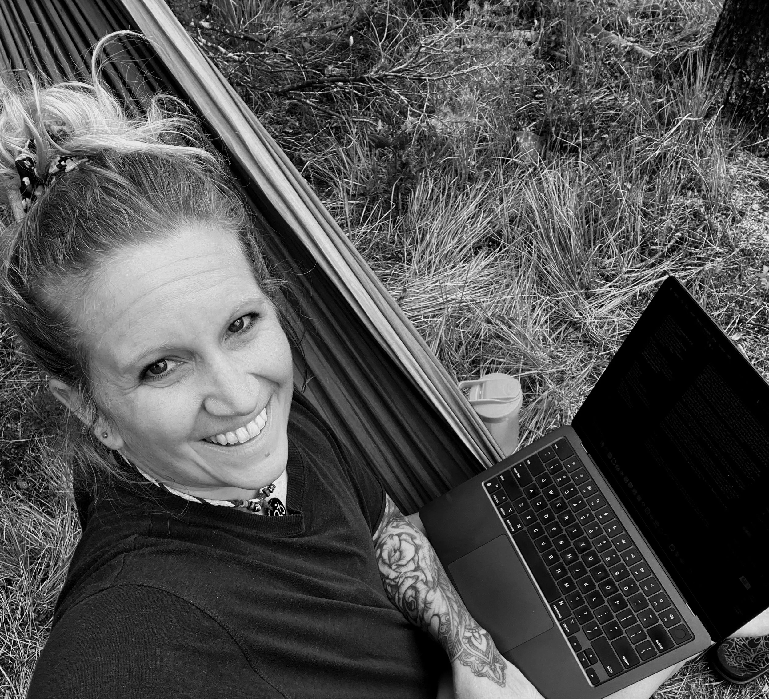 Melissa Lynn Sharp writing The Art of Being Human in a hammock in the wilderness.