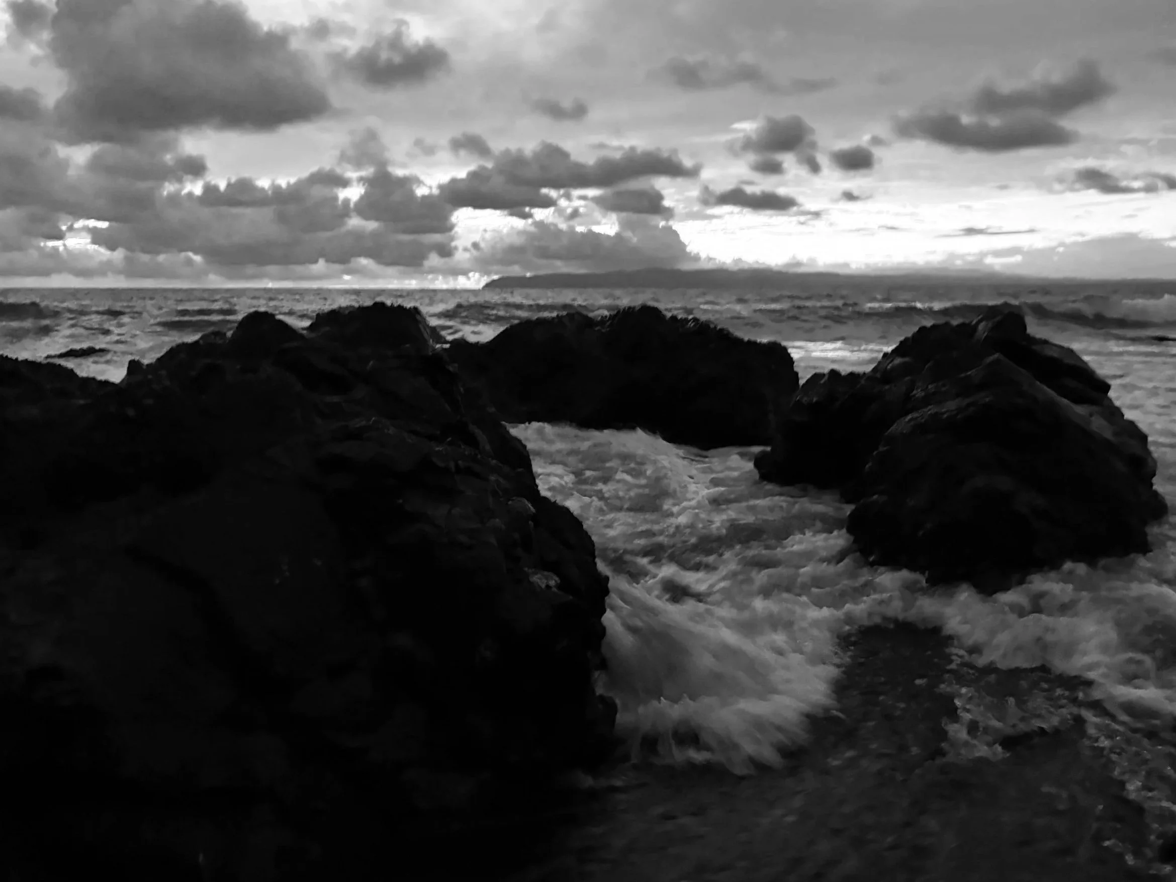 Powerful ocean waves crashing against a rocky Costa Rican shoreline, symbolizing resilience, transformation, and becoming stronger through adversity.