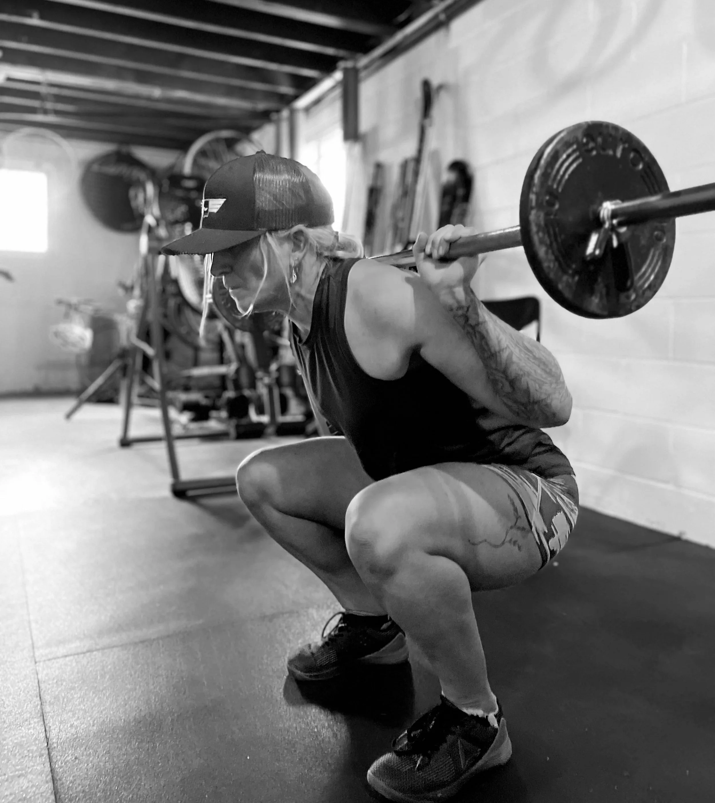 Melissa performing a barbell squat, representing discipline, consistency, and building lasting habits through steady effort.