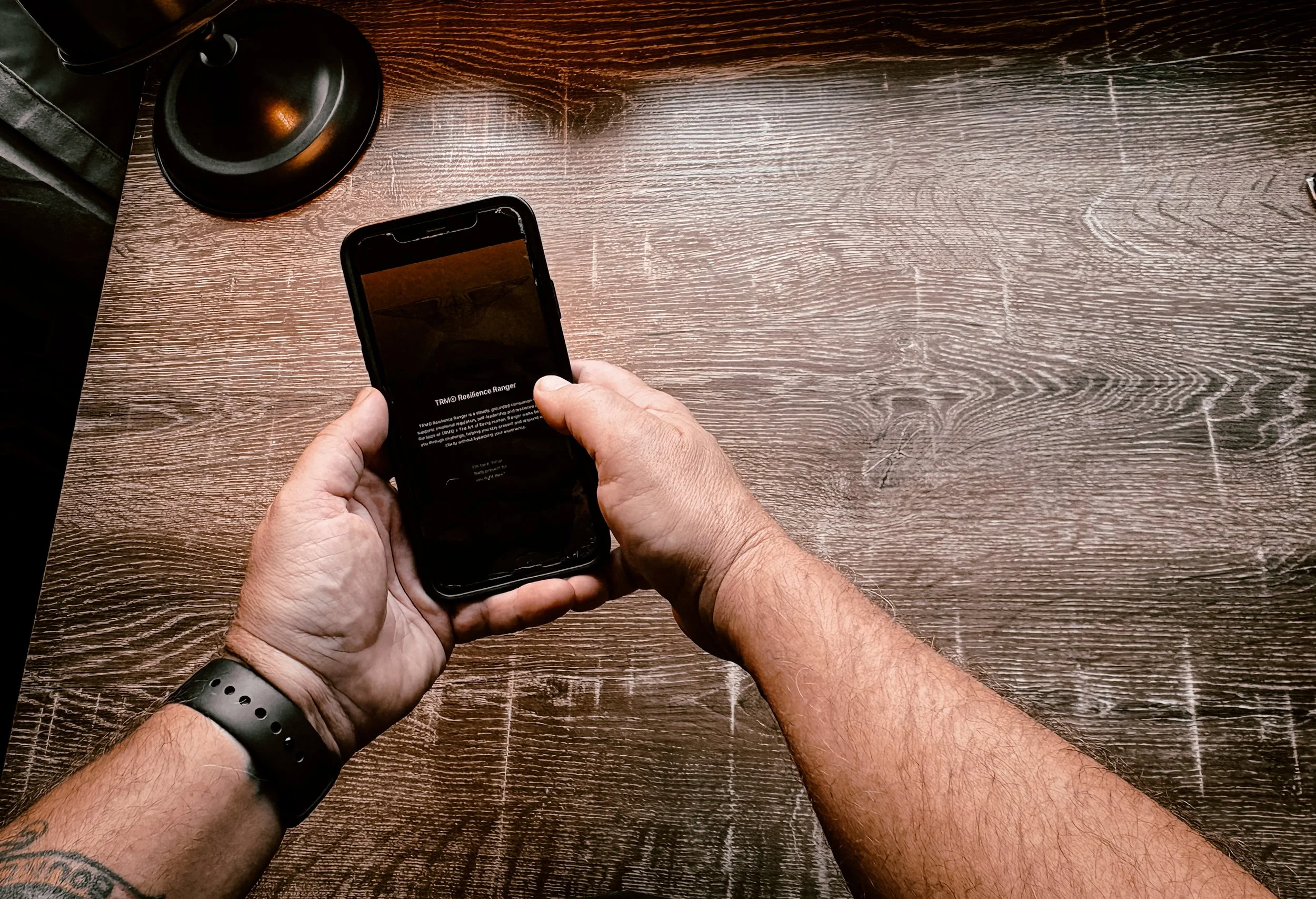 A man holding an iPhone using TRM Resilience Ranger as emotional support.
