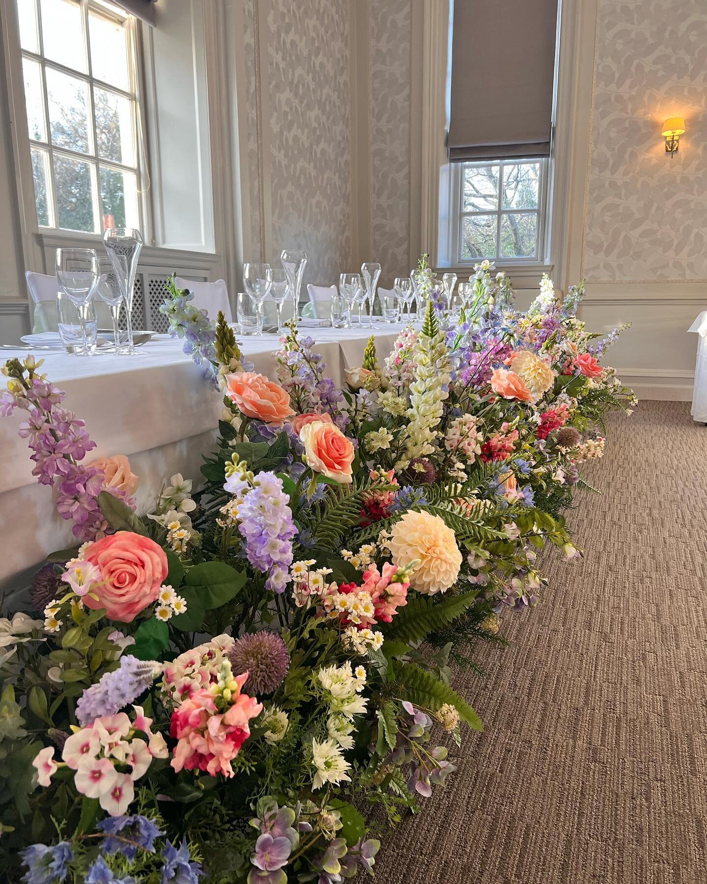 We moved the semi-circular flower meadow from our last post into the wedding breakfast. How lovely is that top table now?  Using a statement piece from ceremony to wedding breakfast means you get more value from your wedding flowers budget #weddingfl