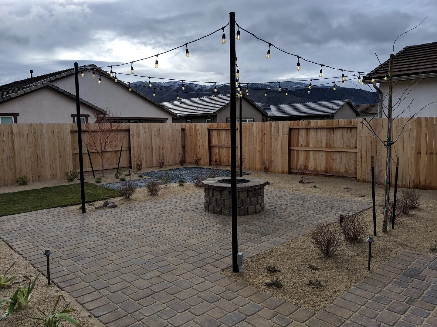 Landscape design in Spanish Springs NV with paver patio and outdoor fireplace