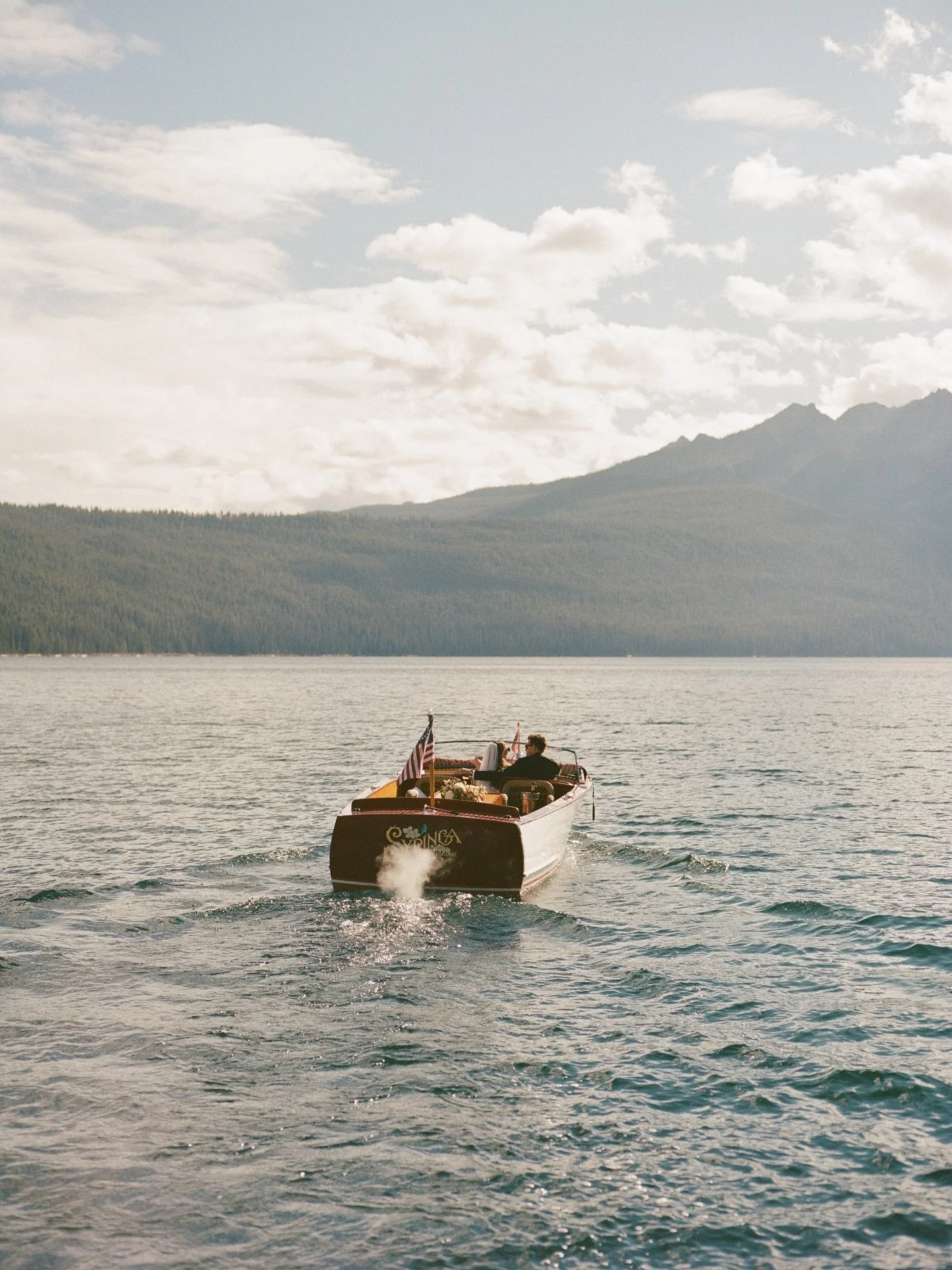 Nothing like a post-ceremony ride on Red Fish Lake⛵️ Part three of Sophie &amp; Kyle&rsquo;s Idaho wedding! 

Mix of film and digital photography

Planning &amp; design | @emilyaitkenevents 
Florals | @floret.designstudio 
Venue | @redfishlakelodge 
