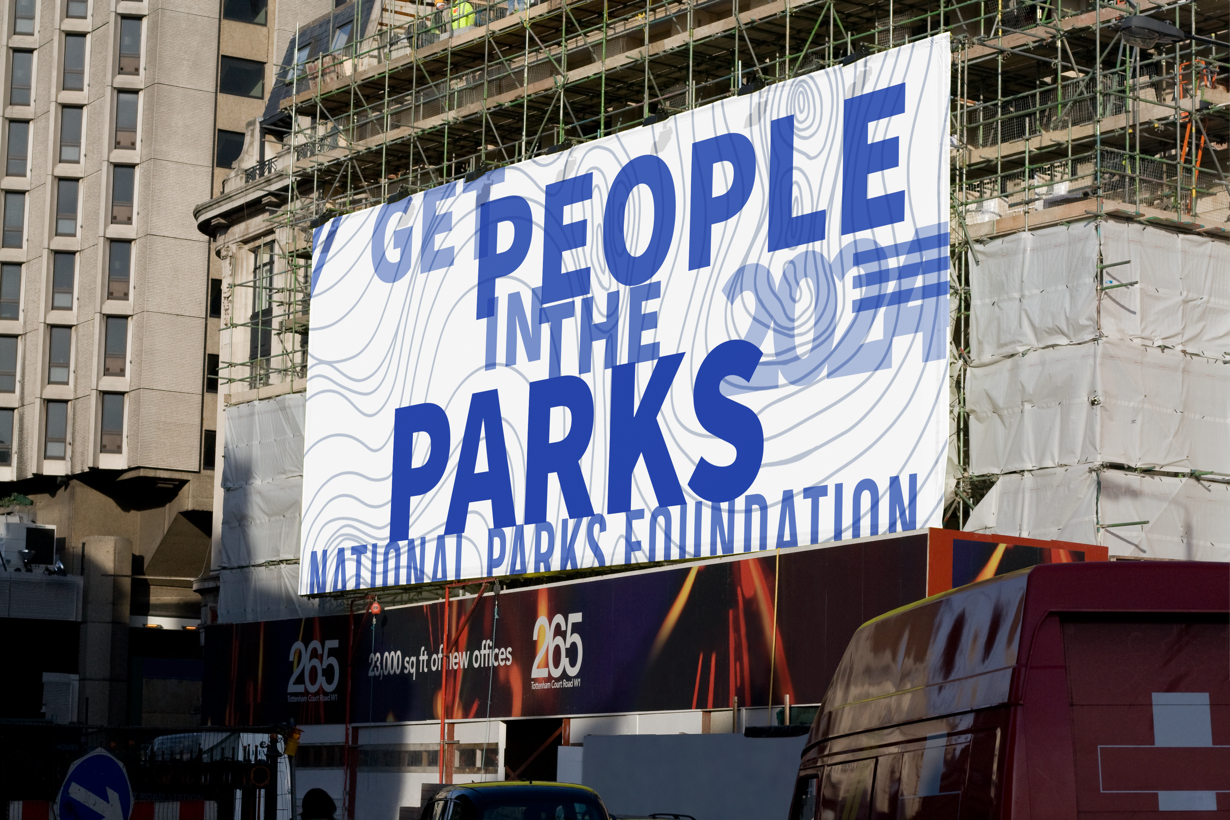 Large billboard reading "Get People in the Parks, National Parks Foundation" on a building under construction, with surrounding scaffolding.