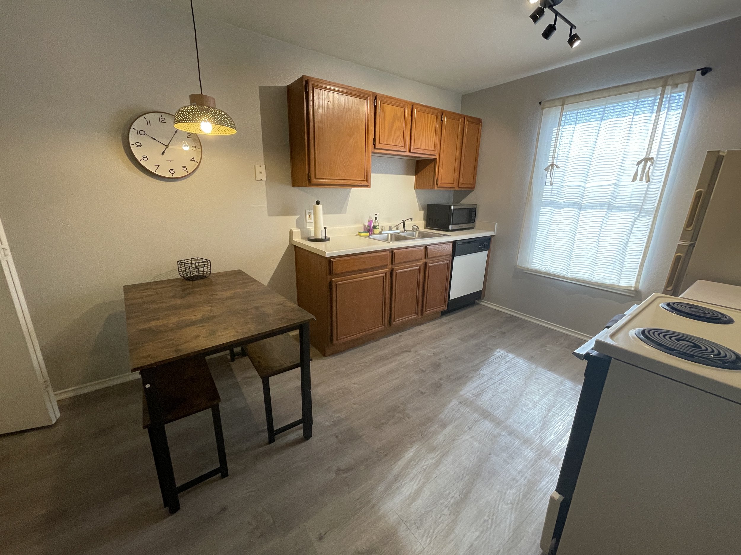 Kitchen Includes: Refrigerator, Stove, Microwave, Pots and Pans, Utensils, Silverware, Plates, Bowls, Cups, Coffee Maker, Toaster, and Trash Can.