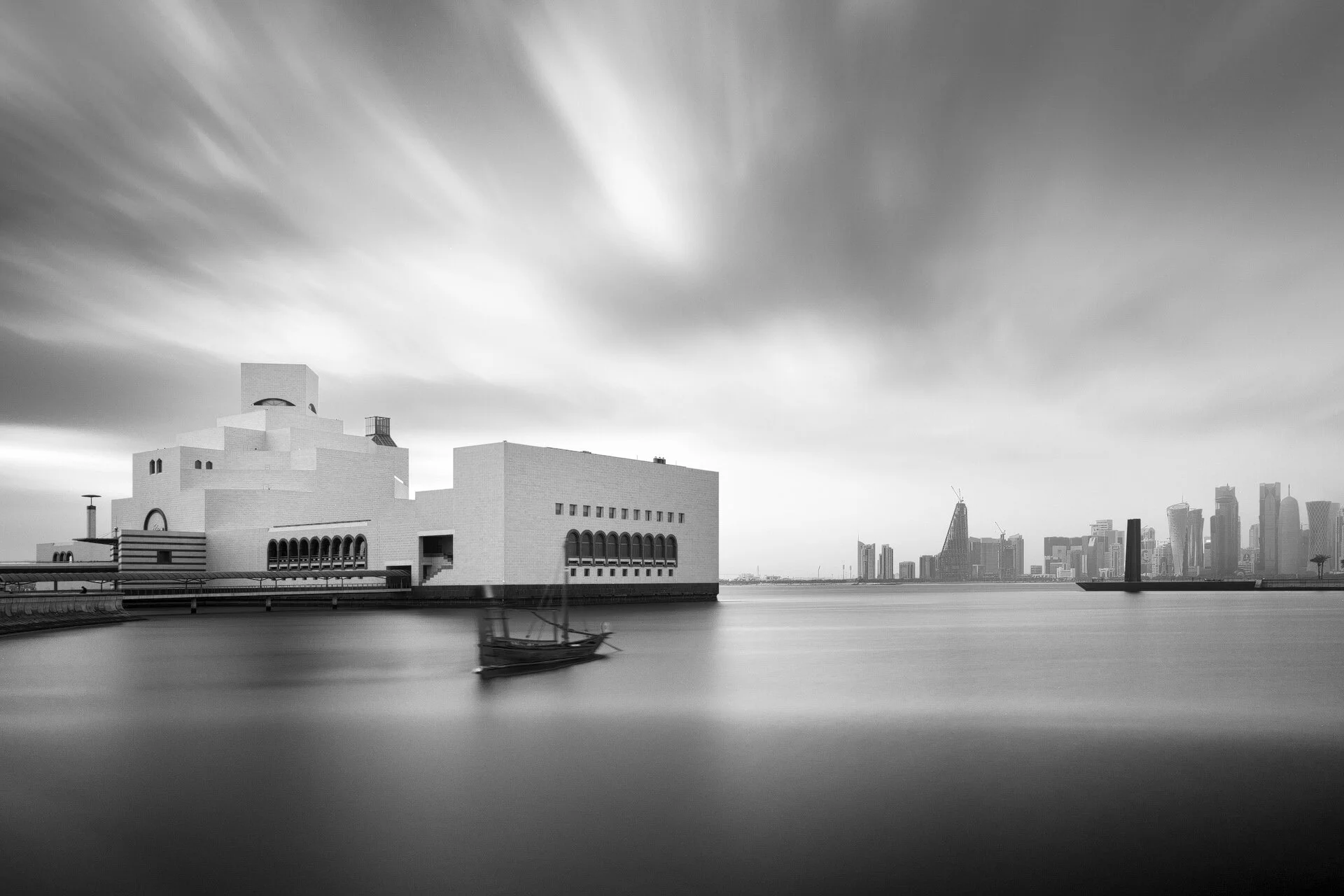 Black and white long exposure photograph of the Museum of Islamic Art and traditional dhow boat in Doha by Hammad Iqbal