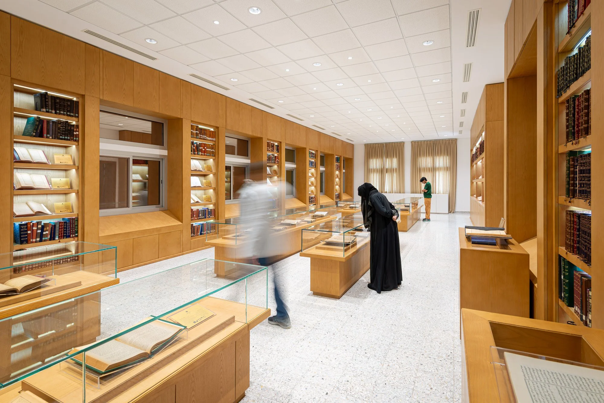 Wide corner perspective shot of the Hall of Rare and Heritage Books showcasing display cases and custom woodwork at Dar Al Kutub library by Hammad Iqbal