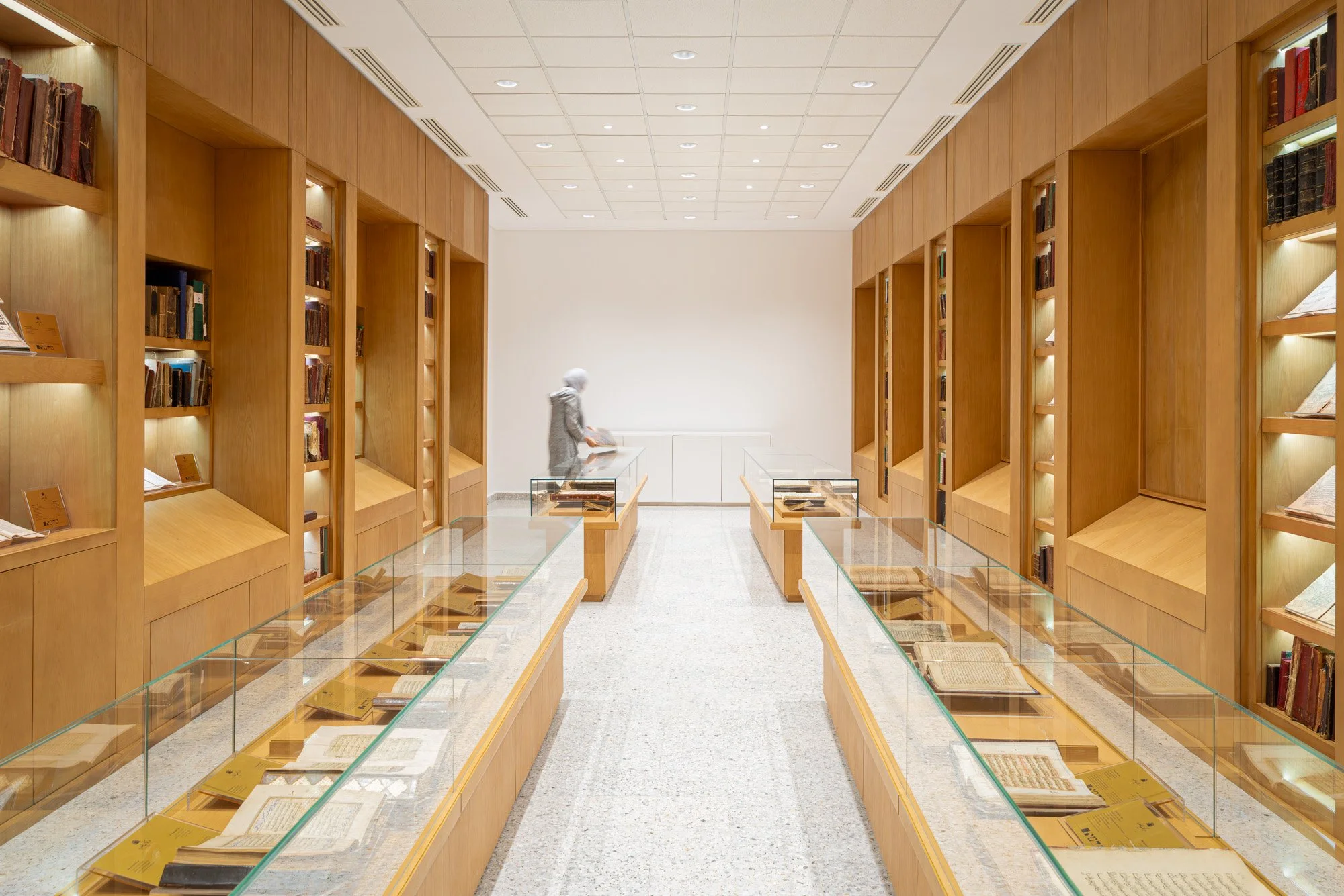 Symmetrical perspective shot of manuscript display cases in the Hall of Rare and Heritage Books at Dar Al Kutub library captured by architectural photographer Hammad Iqbal in Qatar