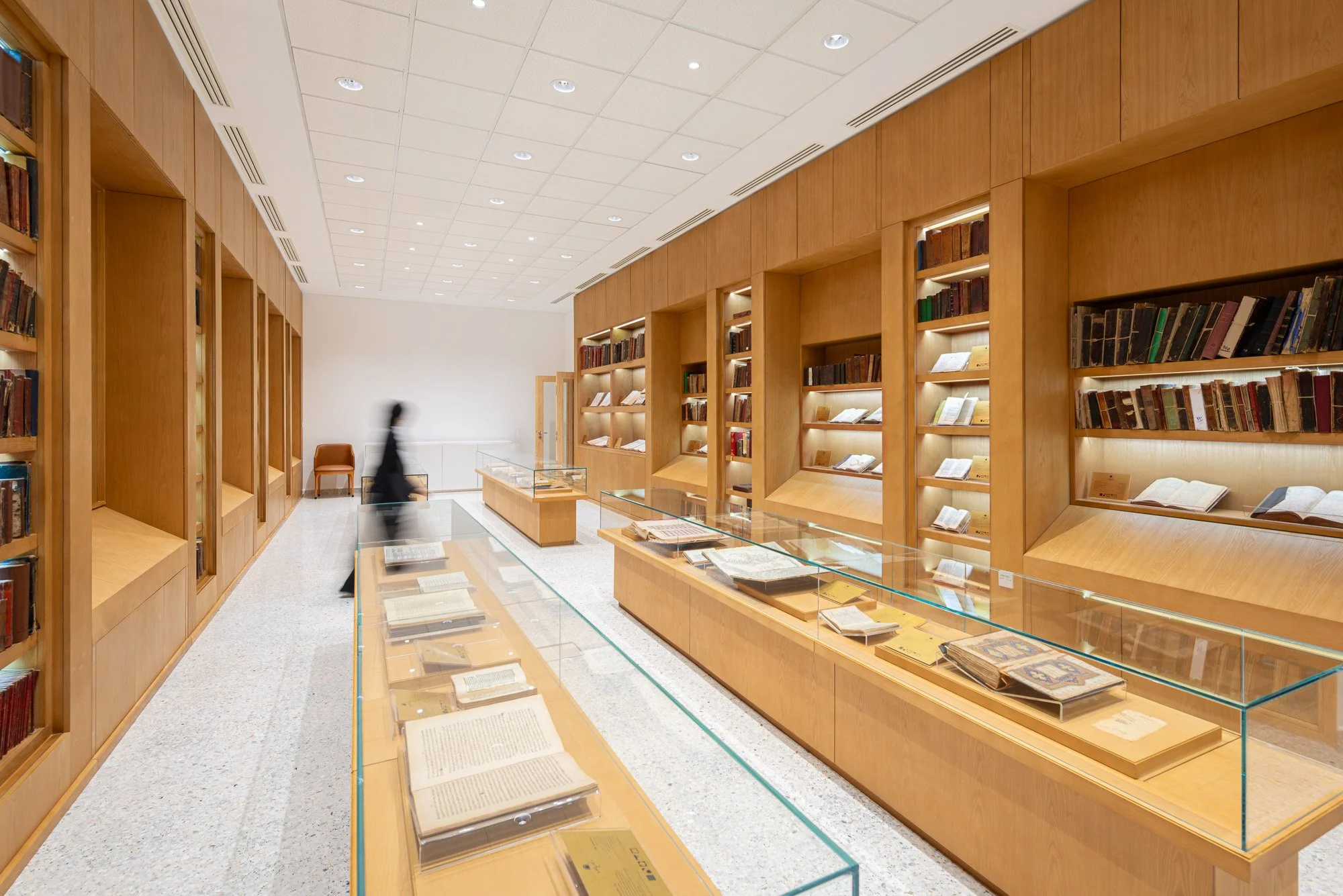 High angle view of glass exhibit cases and custom oak cabinetry in the Hall of Rare and Heritage Books at Dar Al Kutub shot by real estate photographer Hammad Iqbal