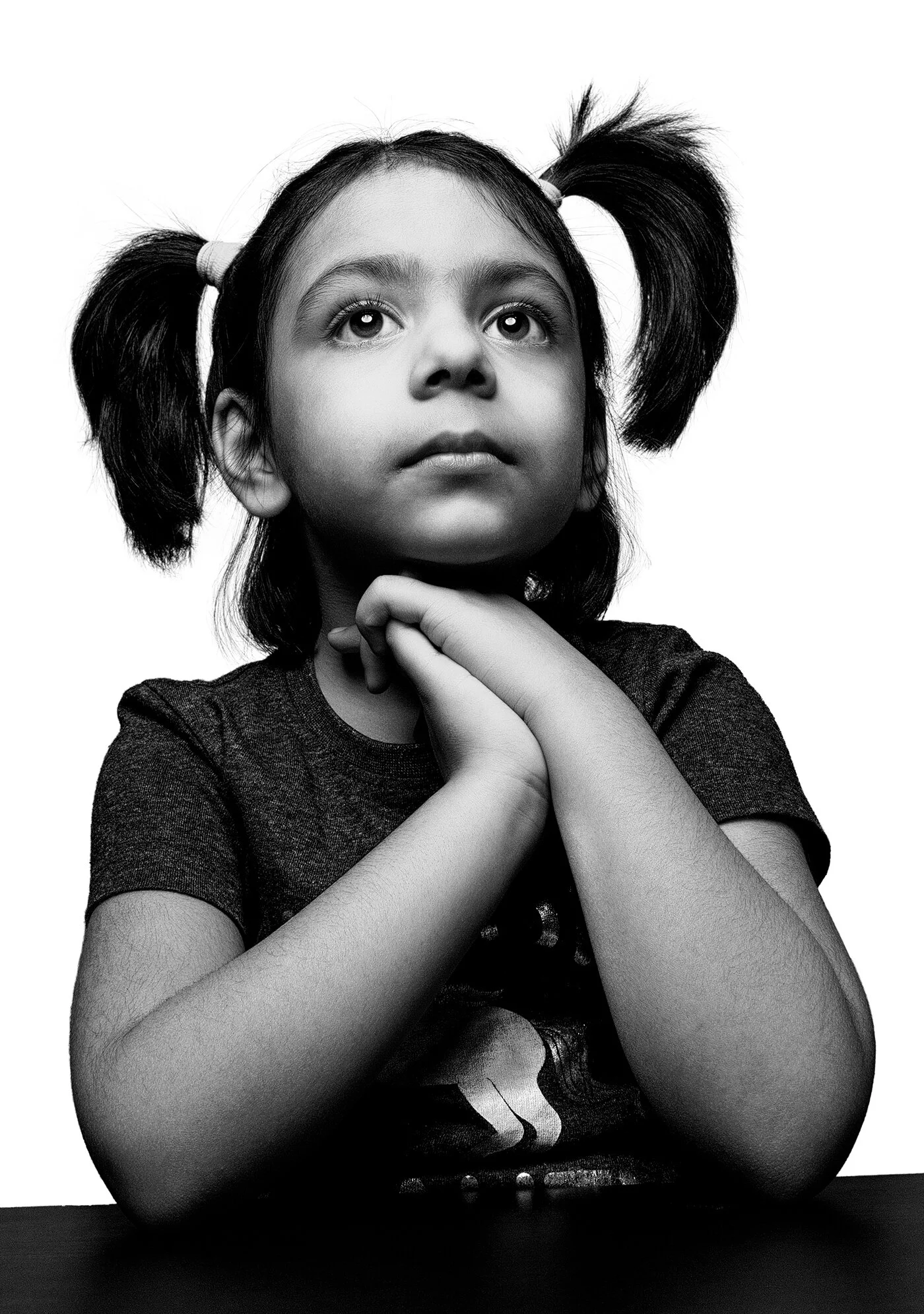 Fine art black and white child portrait with resting chin using wide angle distortion by Hammad Iqbal