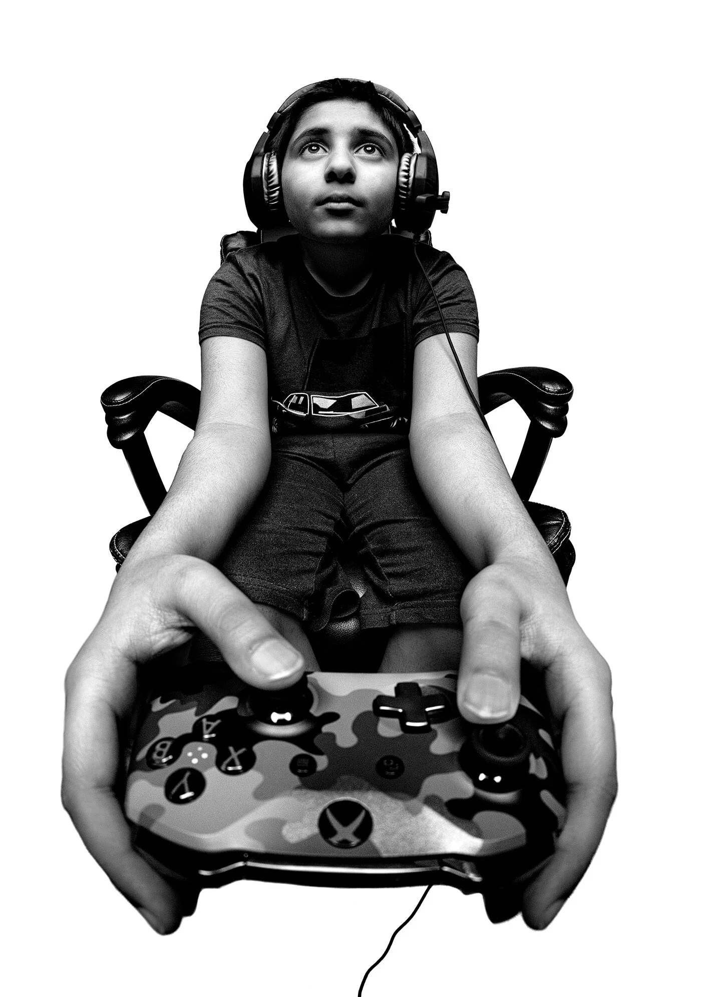 Exaggerated wide angle portrait of boy holding Xbox controller wearing headphones by Hammad Iqbal