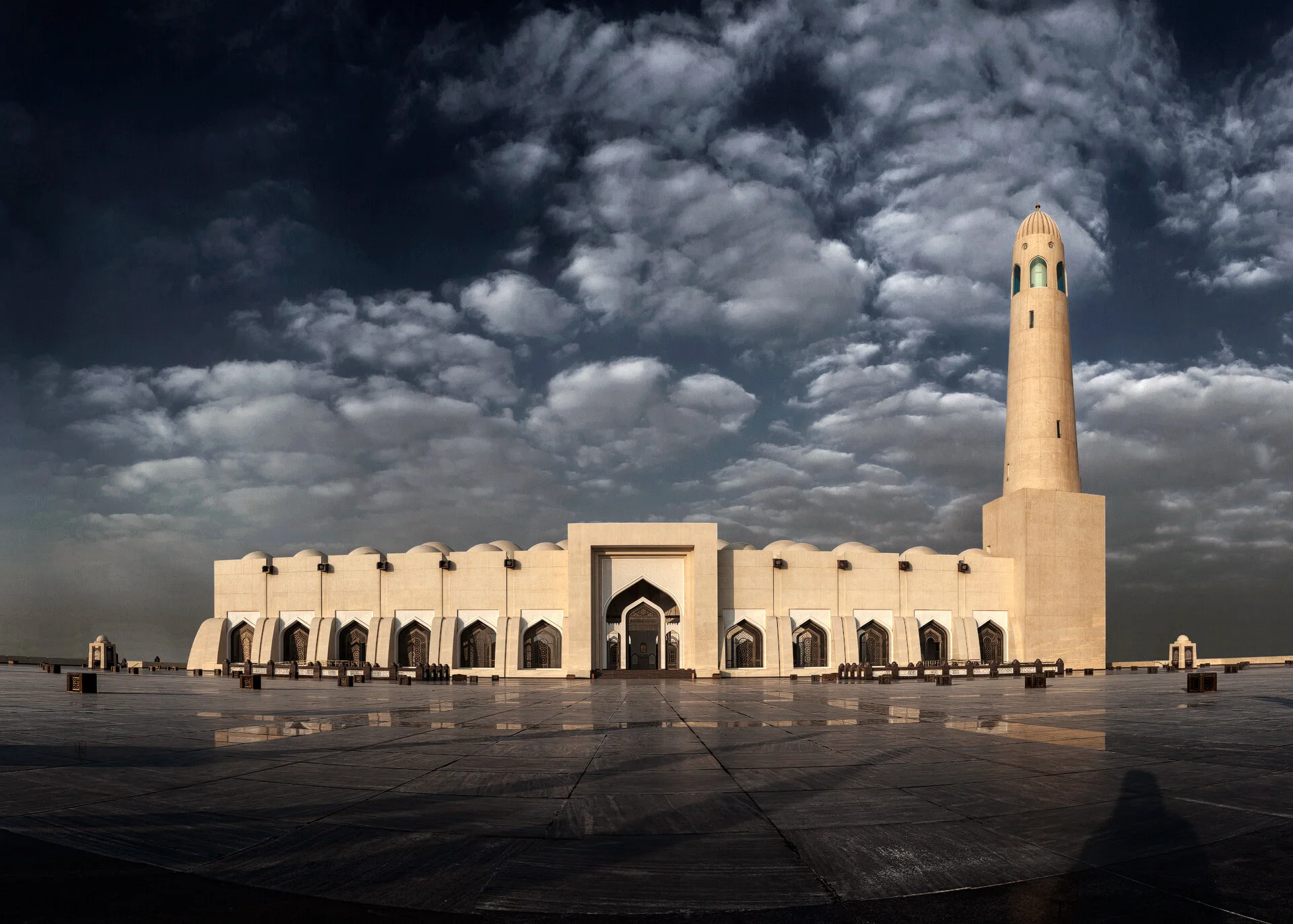 Wide morning exterior panorama photo of Imam Muhammad bin Abdul Wahhab Mosque at sunrise showing courtyard reflections and minaret in Doha Qatar by Hammad Iqbal