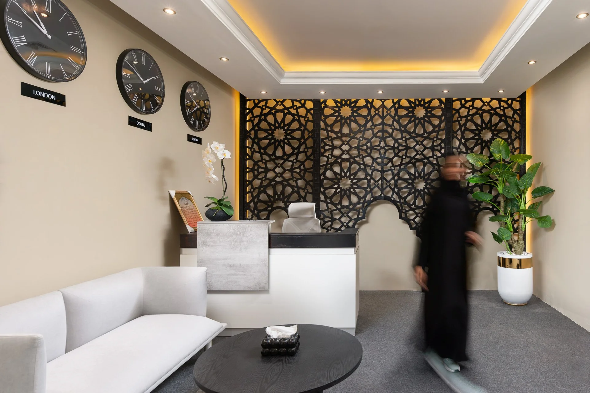 Modern reception lounge with world time zone clocks and a moving figure in a Doha legal consultancy by Hammad Iqbal