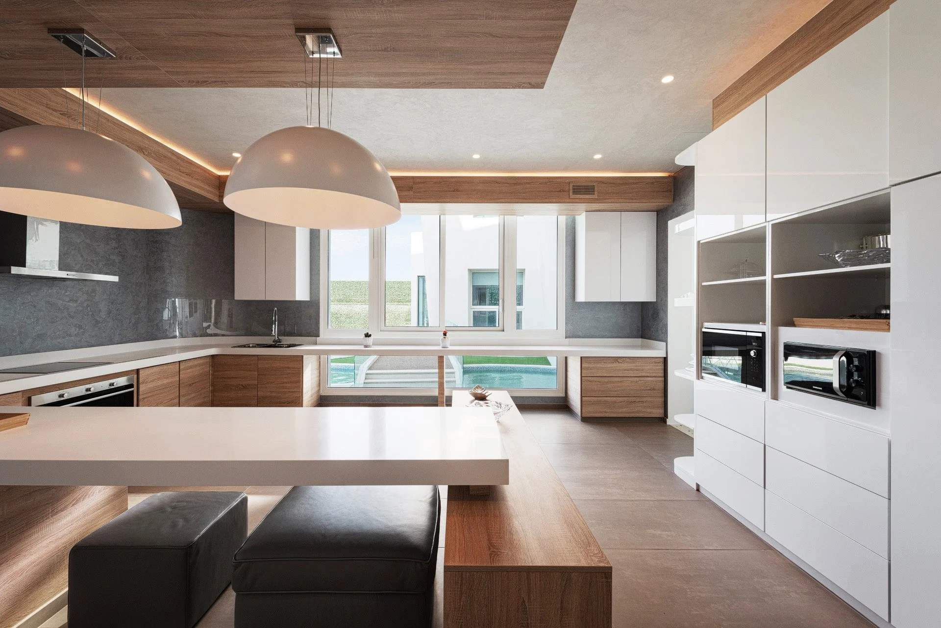 Bright architectural photo of a modern villa kitchen with natural light and custom wood joinery by Hammad Iqbal