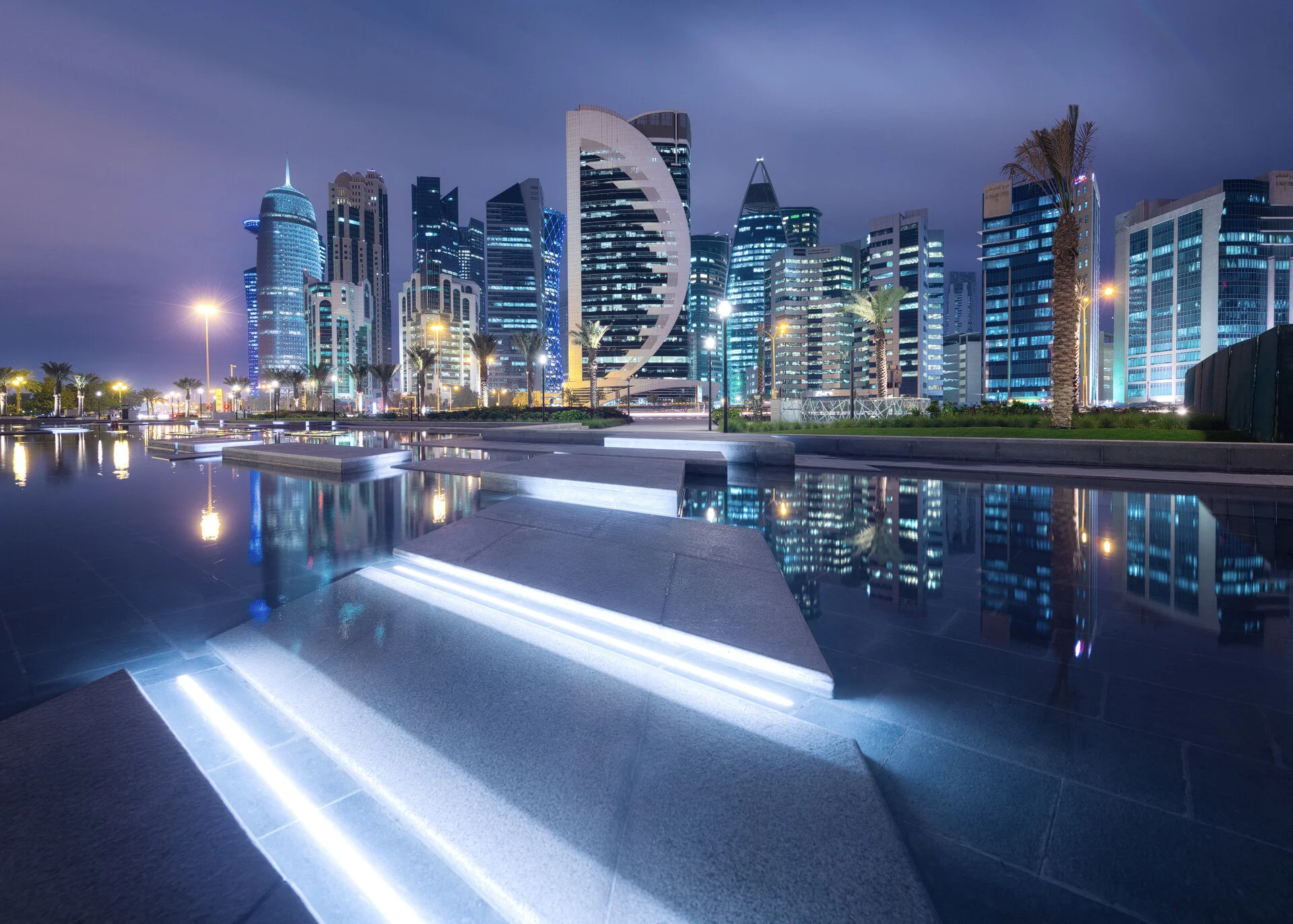 Night photograph of the West Bay Doha skyline reflected in the Hotel Park wading pool near Sheraton Grand Doha by Hammad Iqbal