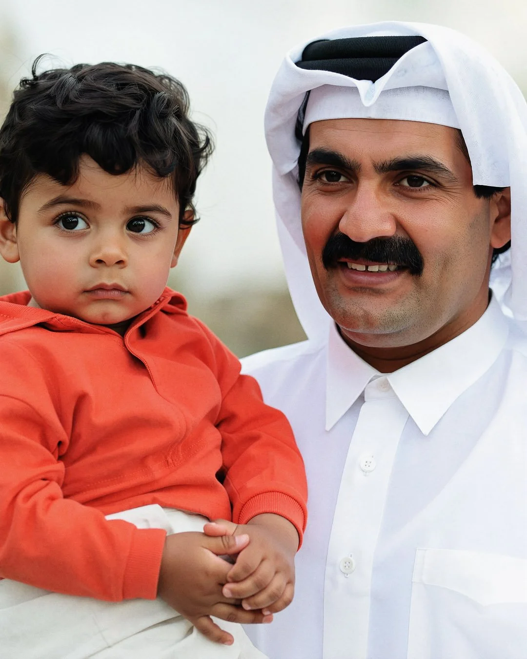  Reconstructed Portrait — Father Amir His Highness Sheikh Hamad bin Khalifa Al Thani holding a child. 