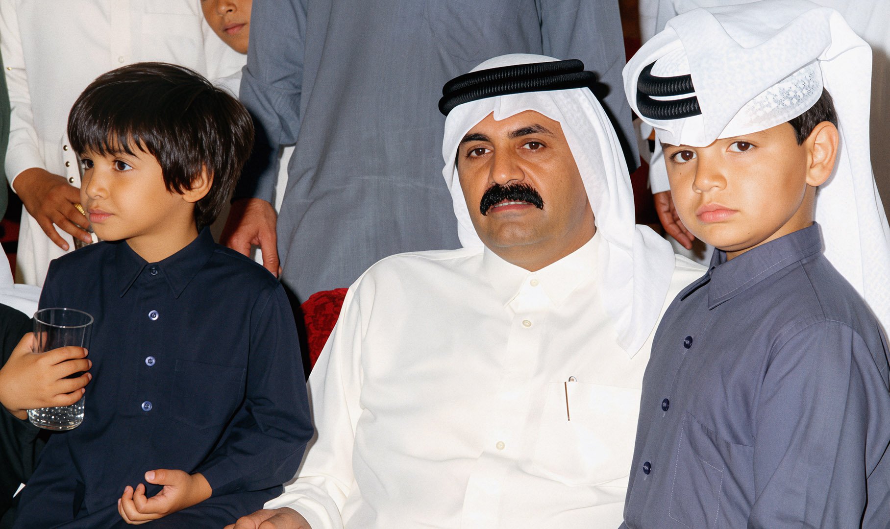  Reconstructed Image — His Highness Sheikh Hamad bin Khalifa Al Thani seated alongside young Qatari royals. 