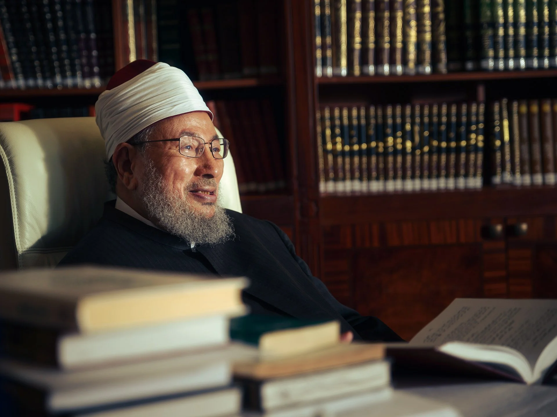 Thumbnail for rare environmental portrait of the late Sheikh Yusuf Al-Qaradawi in his home library in Doha photographed by Hammad Iqbal