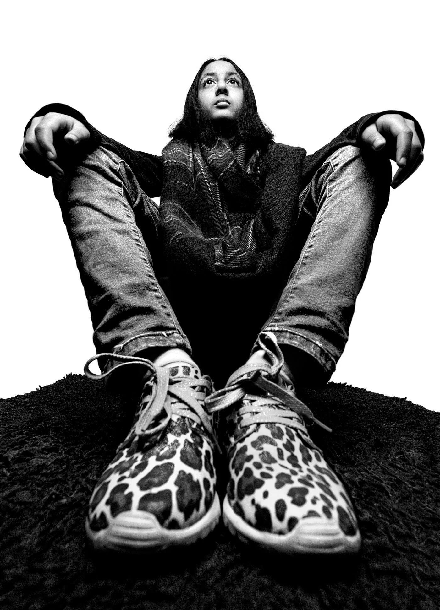 Low angle forced perspective portrait with leopard print sneakers in foreground by Hammad Iqbal