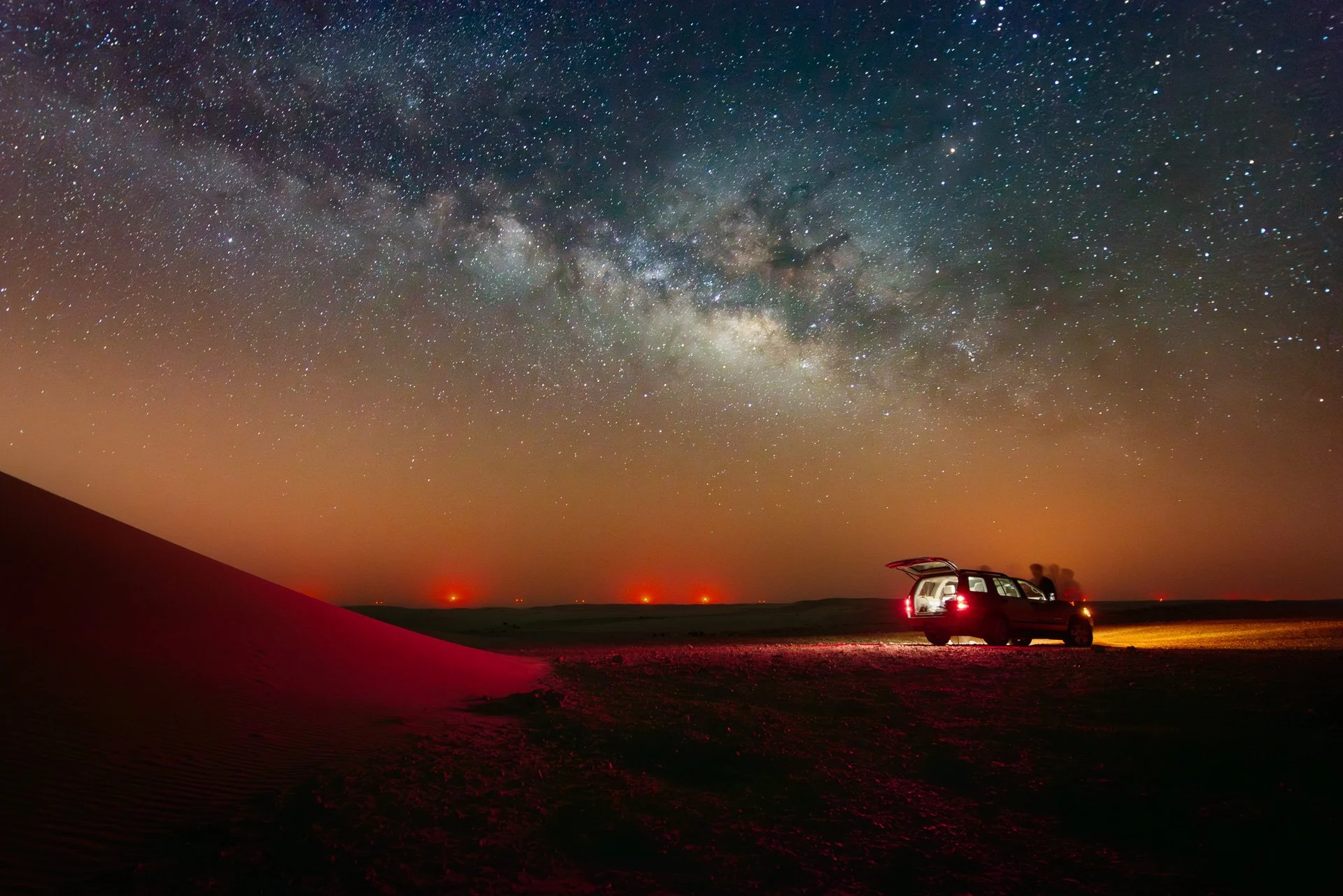 Night landscape showing an off-road 4x4 vehicle parked under a starry Milky Way sky in the Qatari desert by Hammad Iqbal