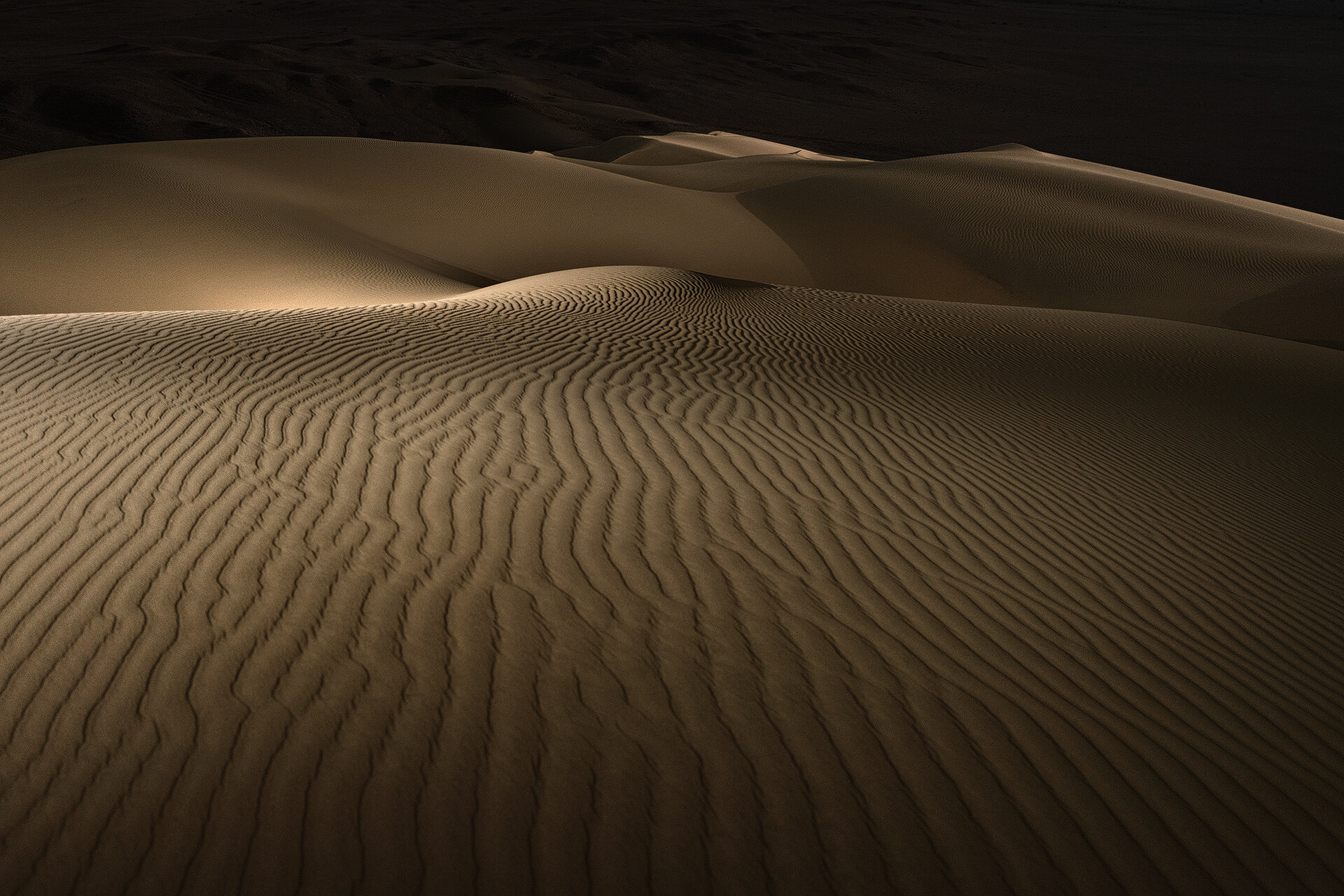 Close up texture photograph of wind formed sand ripples in Qatari desert illuminated at night by Hammad Iqbal