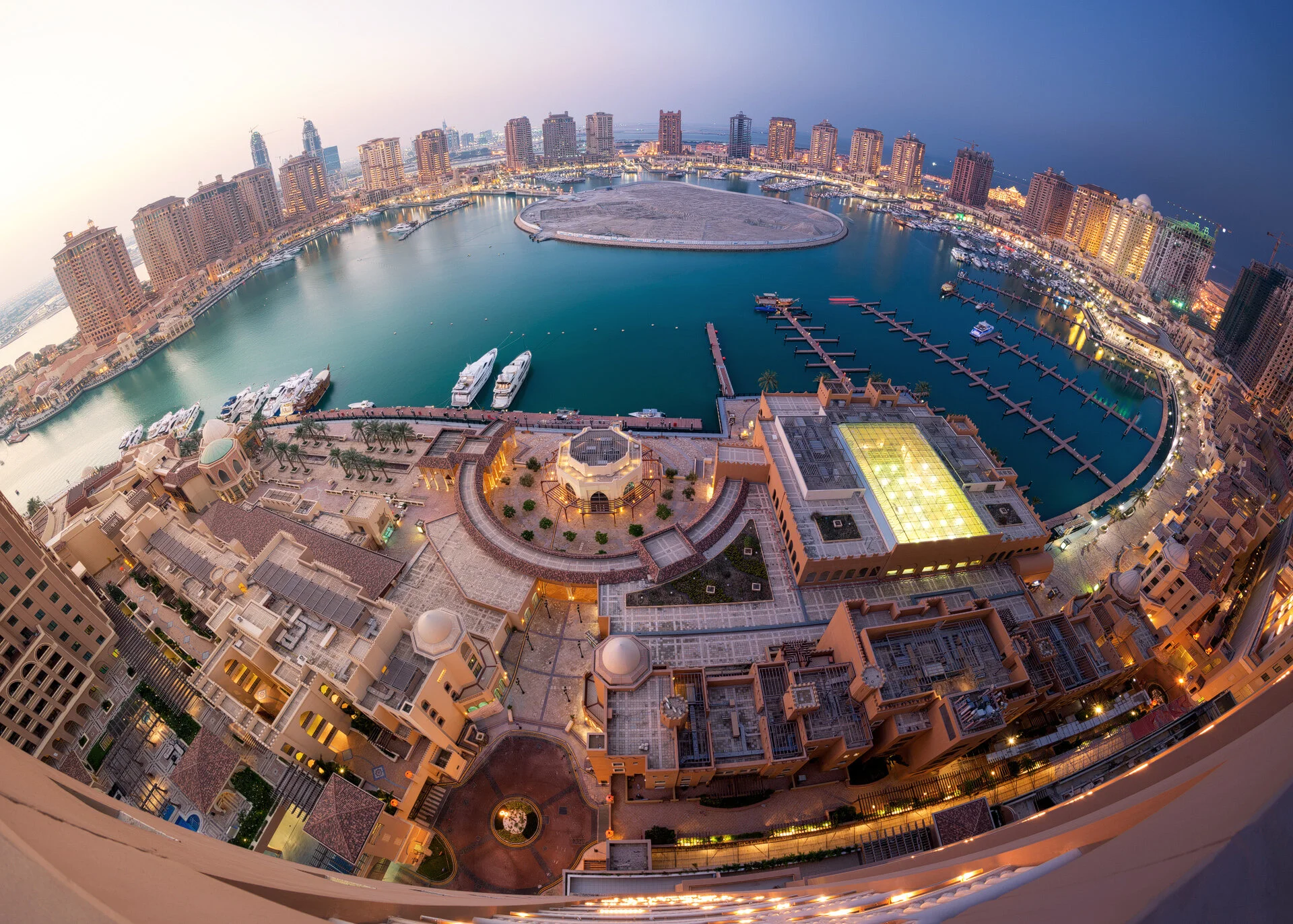 Panoramic fisheye aerial photo of Porto Arabia marina at The Pearl Qatar showing a seamless day to night transition composite from left to right by Hammad Iqbal
