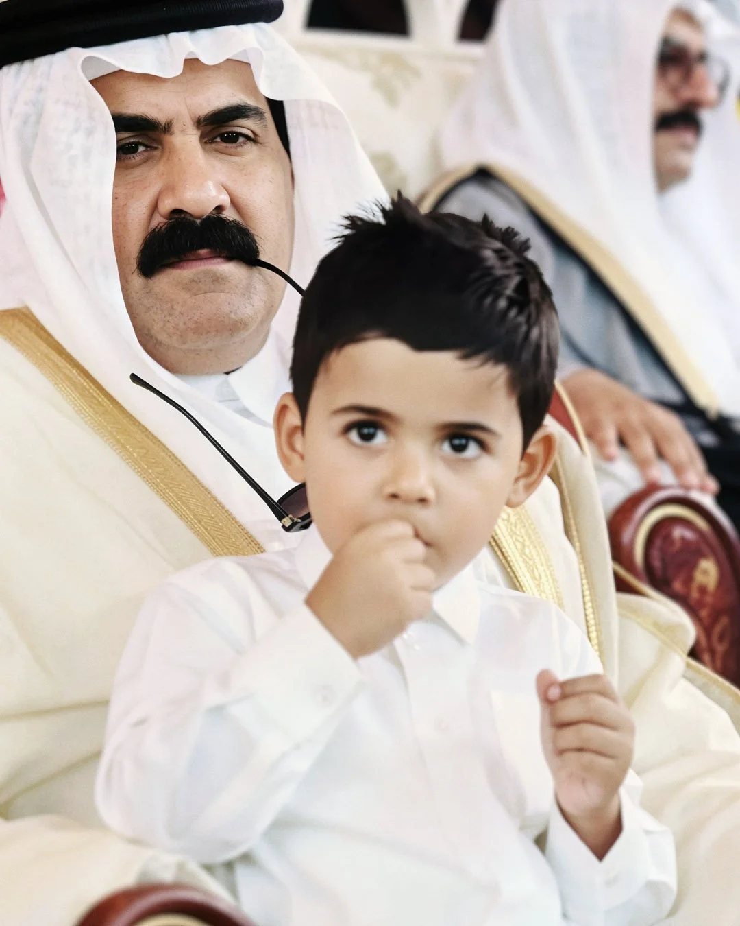  Reconstructed Image — Public candid moment featuring His Highness Sheikh Hamad bin Khalifa Al Thani with a child. 