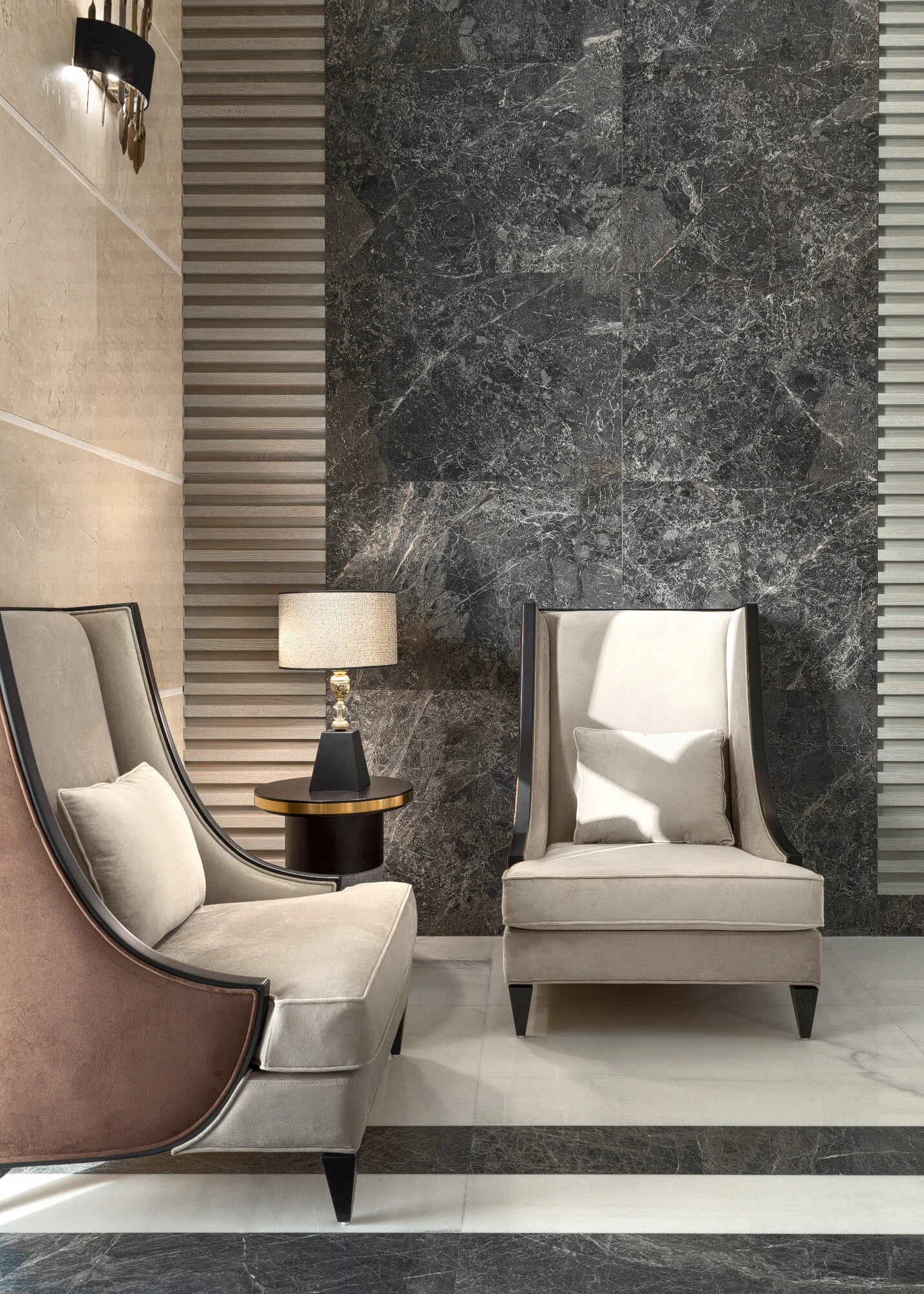 Architectural vignette of a luxury seating nook with dark polished marble wall travertine panels and high back armchair in West Wukair villa photographed by Hammad Iqbal