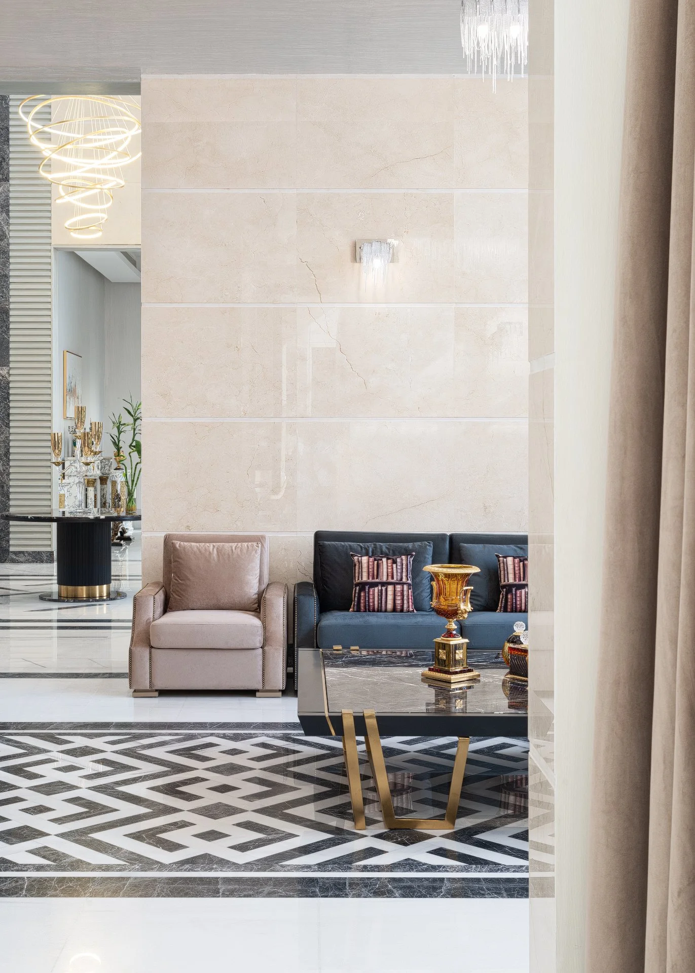 Framed view of a formal luxury lounge majlis with geometric marble floor inlay brass coffee table and travertine wall in a Qatar villa by Hammad Iqbal