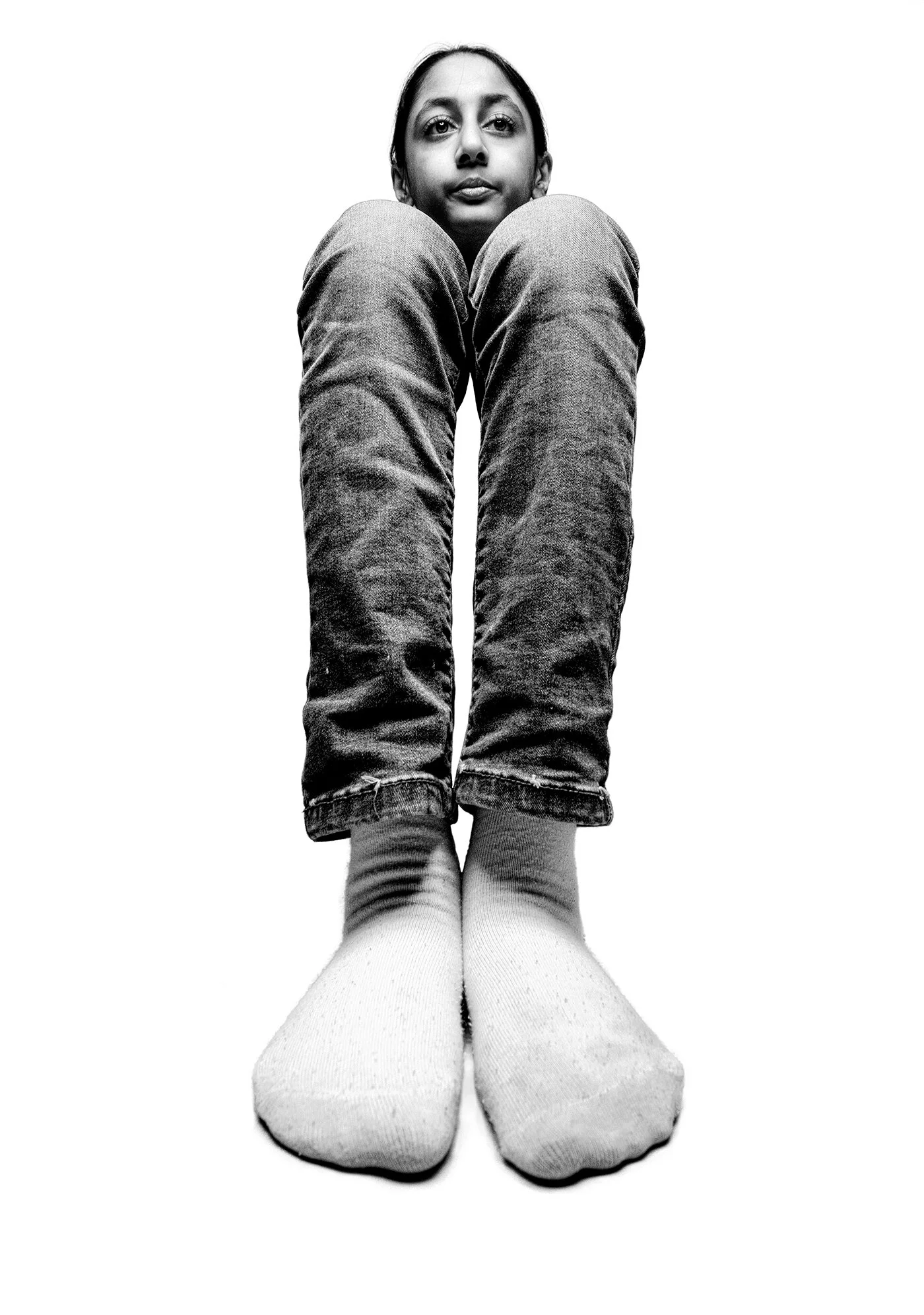 Vertical wide angle photo emphasizing legs and feet in isolation portrait by Hammad Iqbal